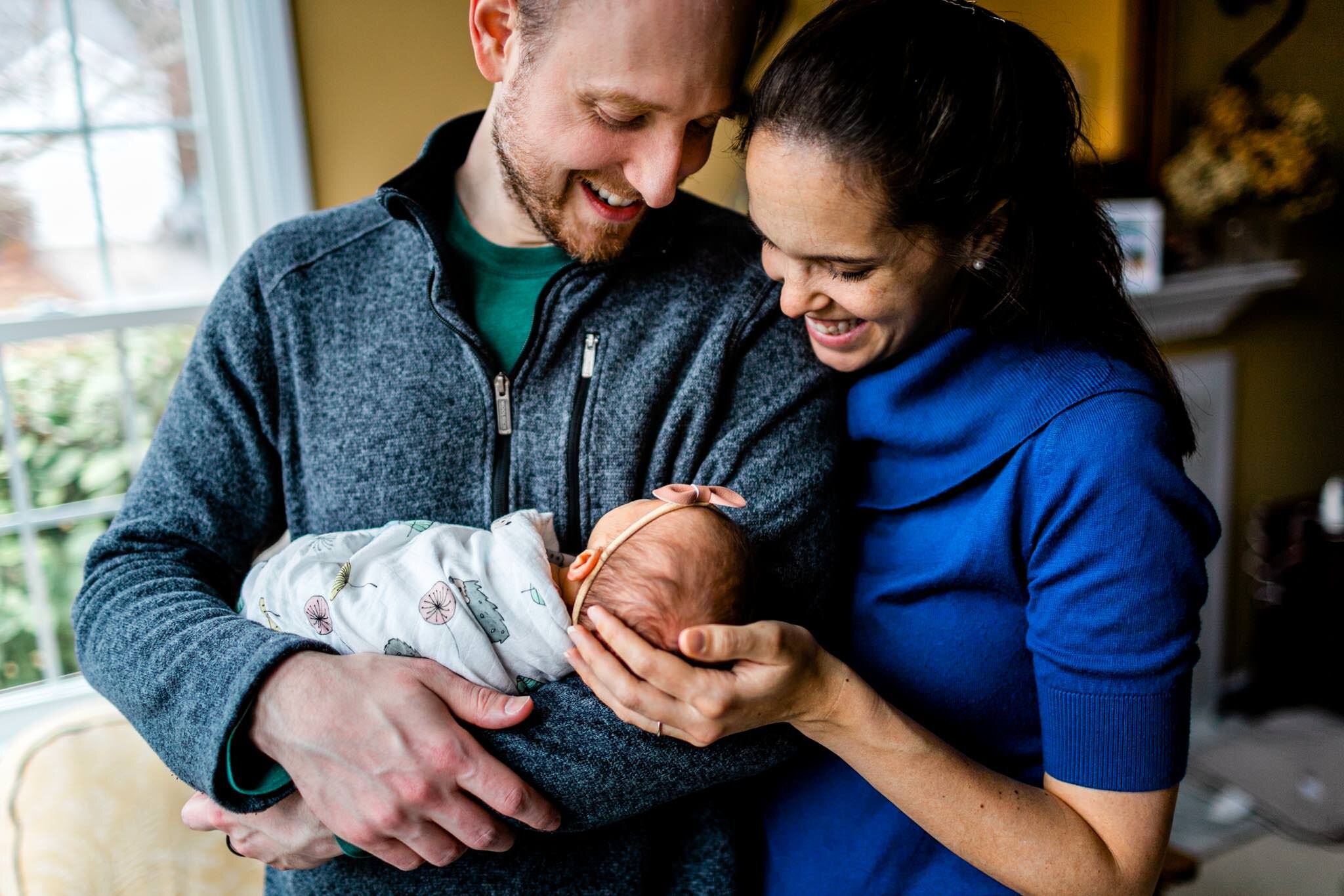 Durham Newborn Photographer | By G. Lin Photography | Father and mother standing while holding baby