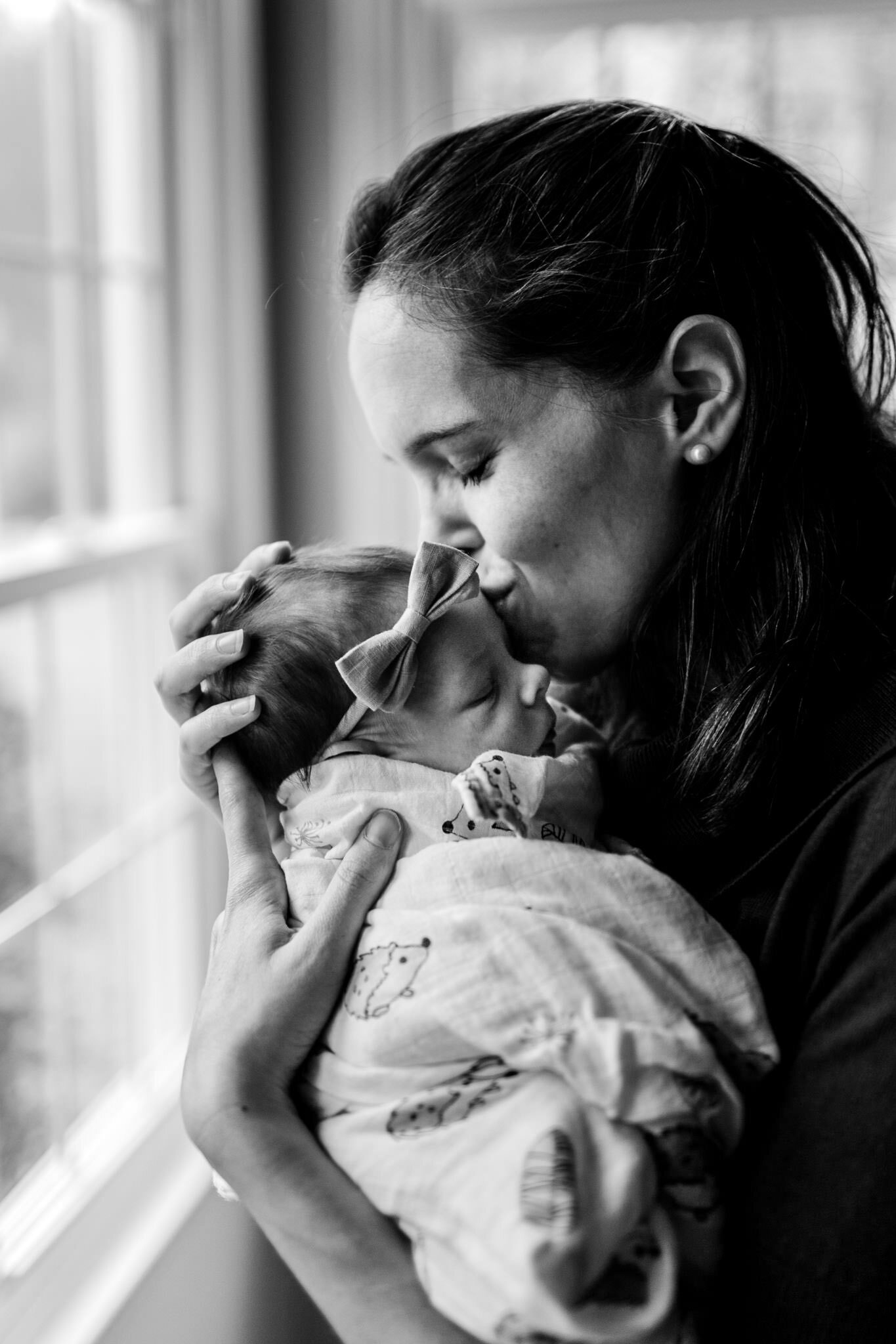 Durham Newborn Photographer | By G. Lin Photography | Black and white photo of woman kissing baby girl on forehead