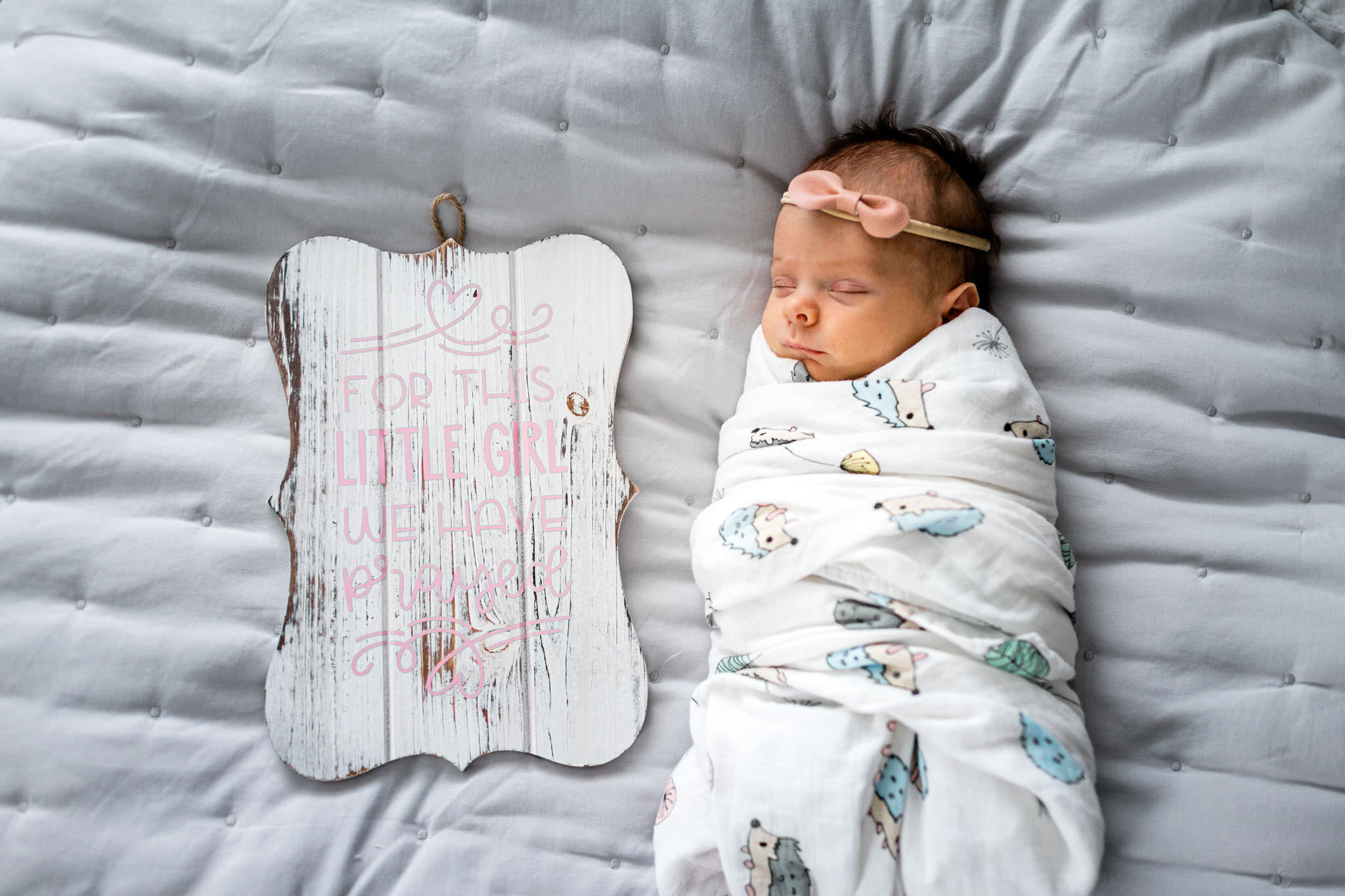 Durham Newborn Photographer | By G. Lin Photography | Baby girl with sign laying on bed