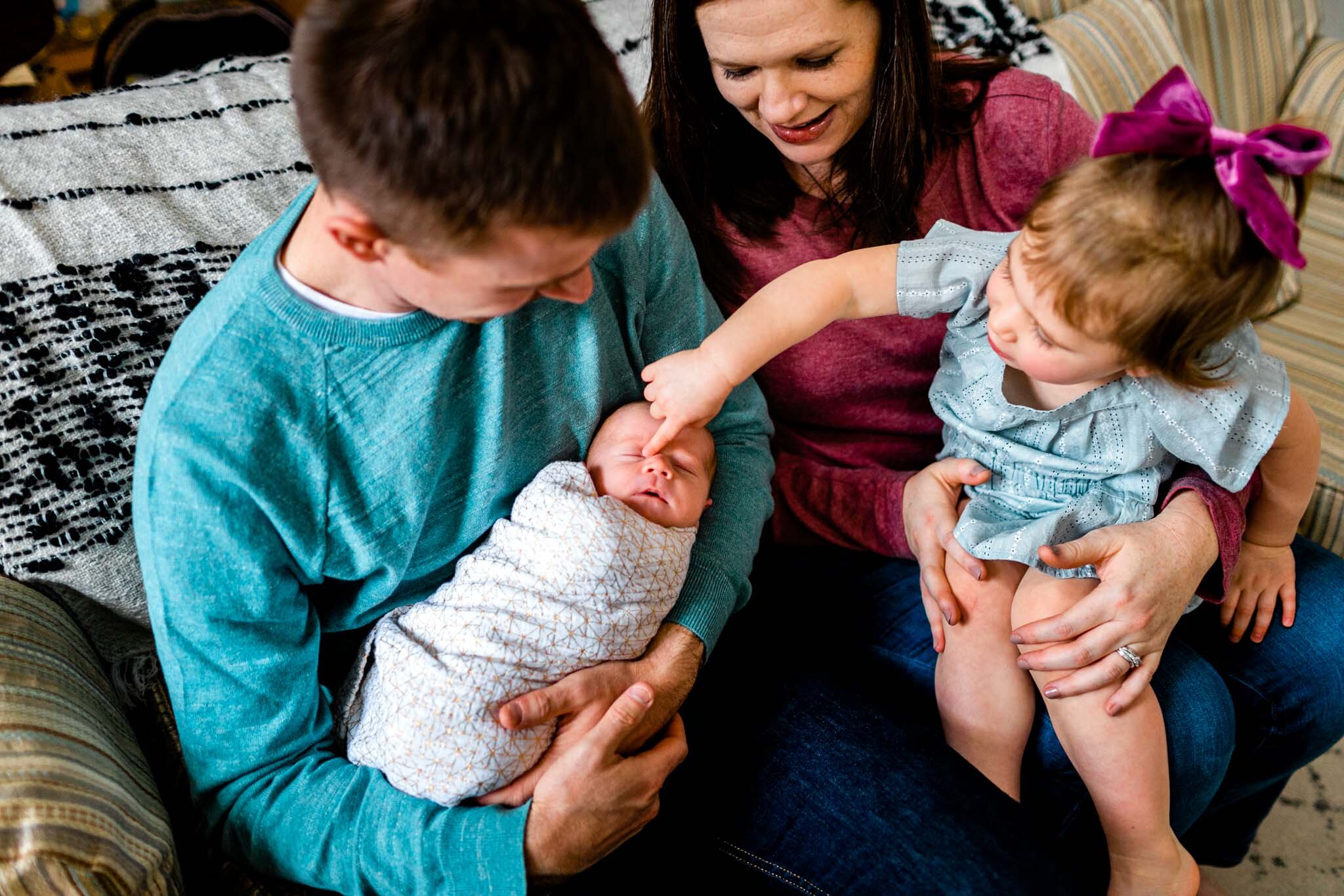 Hillsborough Newborn Photographer | By G. Lin Photography | Family sitting on couch with baby