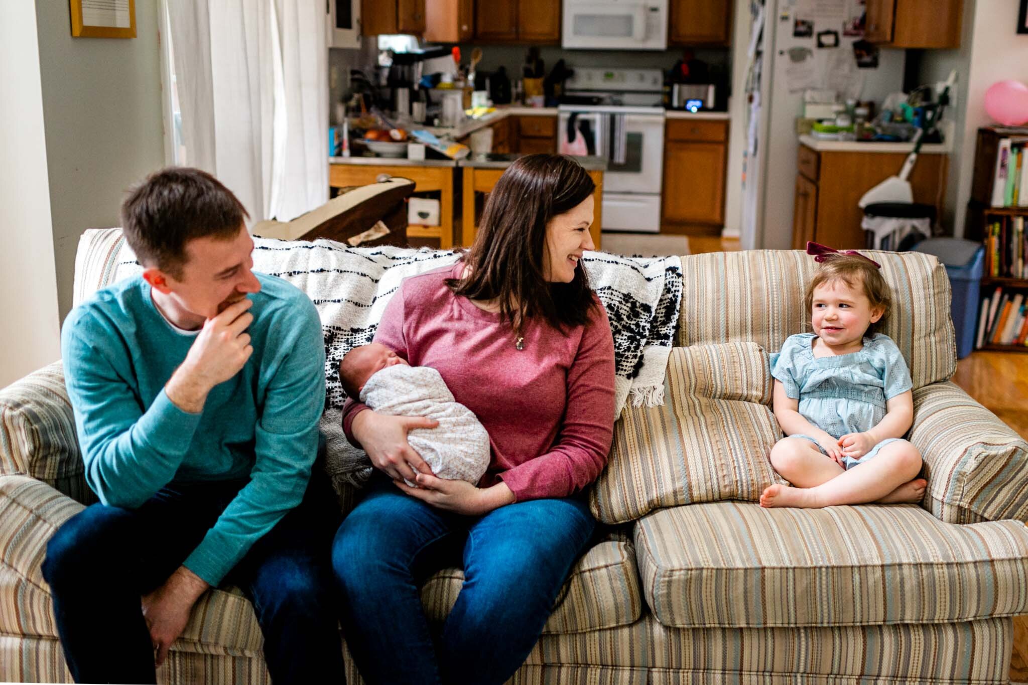 Hillsborough Newborn Photographer | By G. Lin Photography | Family laughing and sitting together on couch
