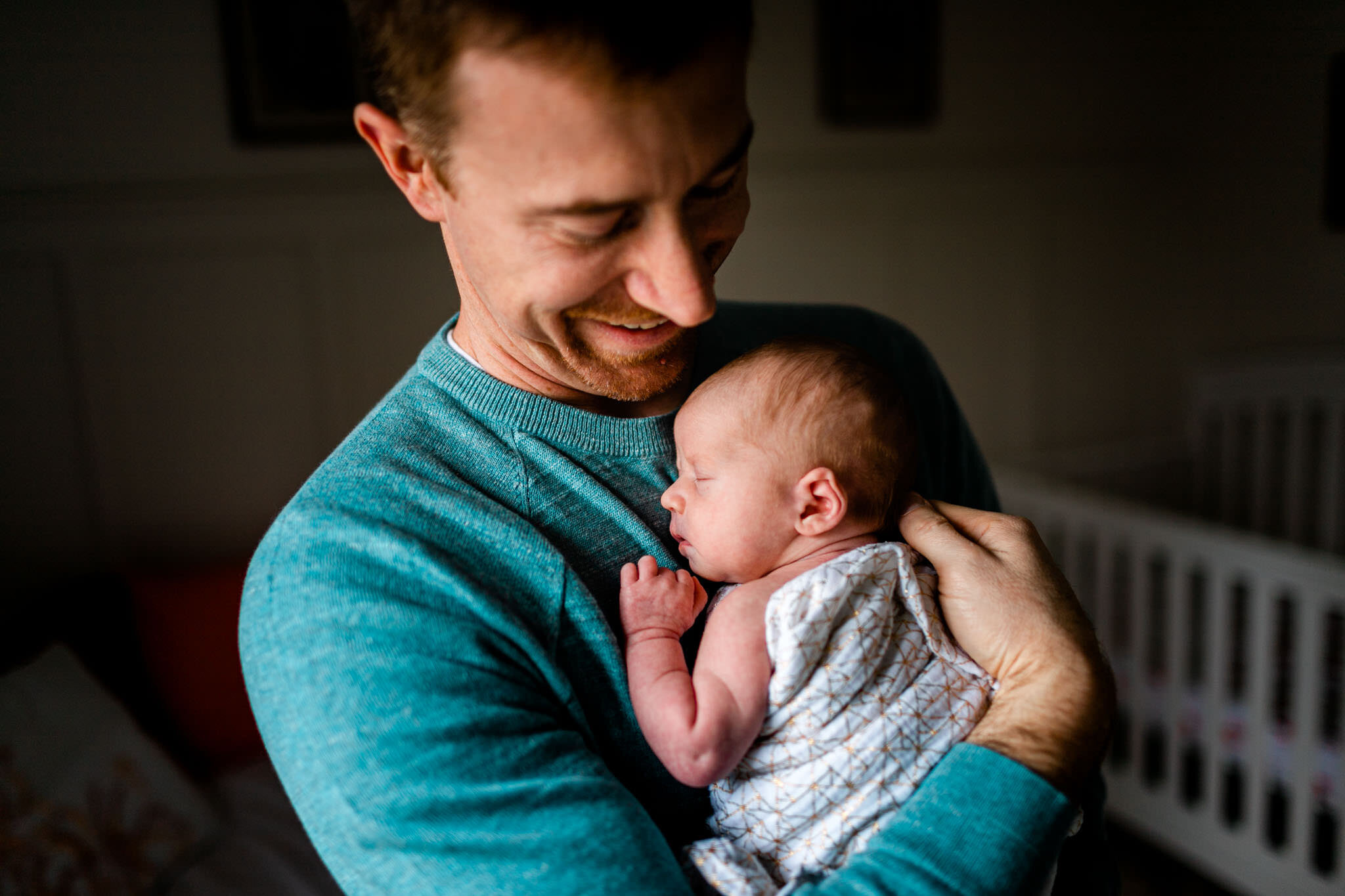 Hillsborough Newborn Photographer | By G. Lin Photography | Candid photo of dad holding baby by window