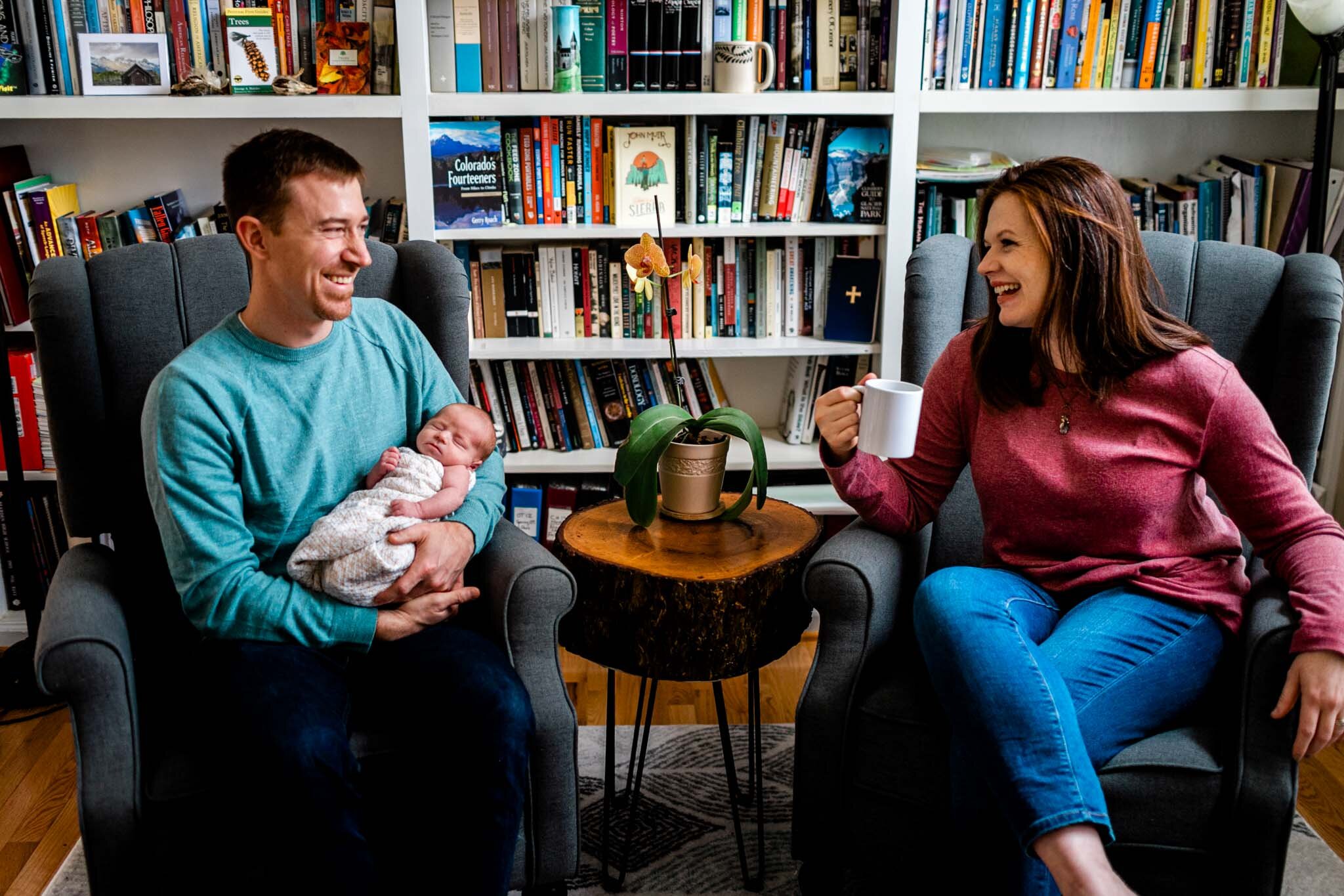 Hillsborough Newborn Photographer | By G. Lin Photography | Parents sitting next to bookcase