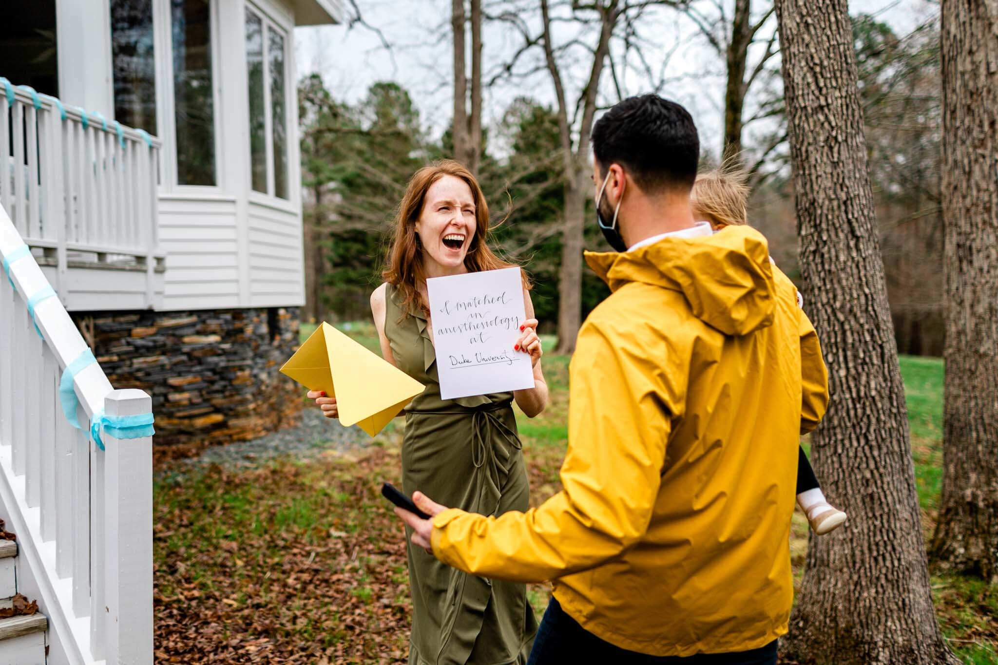 Durham Family Photographer | By G. Lin Photography | Match Day | Woman looking at man while holding letter and laughing