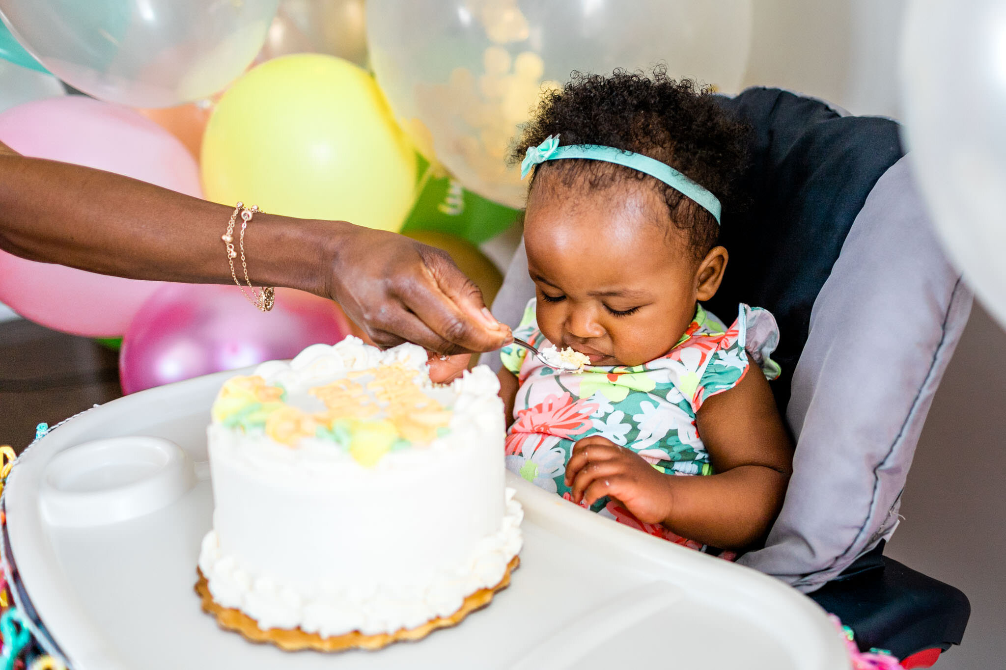 Durham Family Photographer | By G. Lin Photography | Mother spoon feeding cake to baby