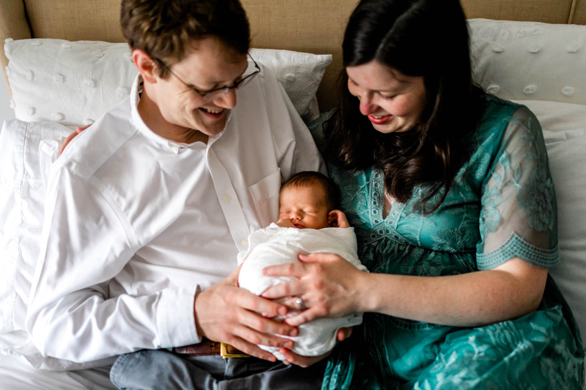 Durham Newborn Photographer | By G. Lin Photography | Man and woman looking down and holding baby