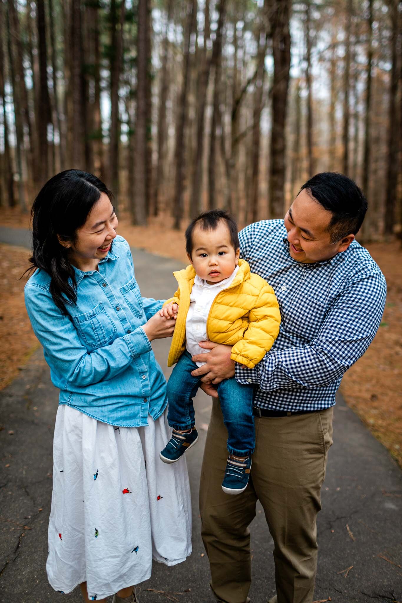 Raleigh Family Photographer | By G. Lin Photography | Umstead Park | Parents holding baby