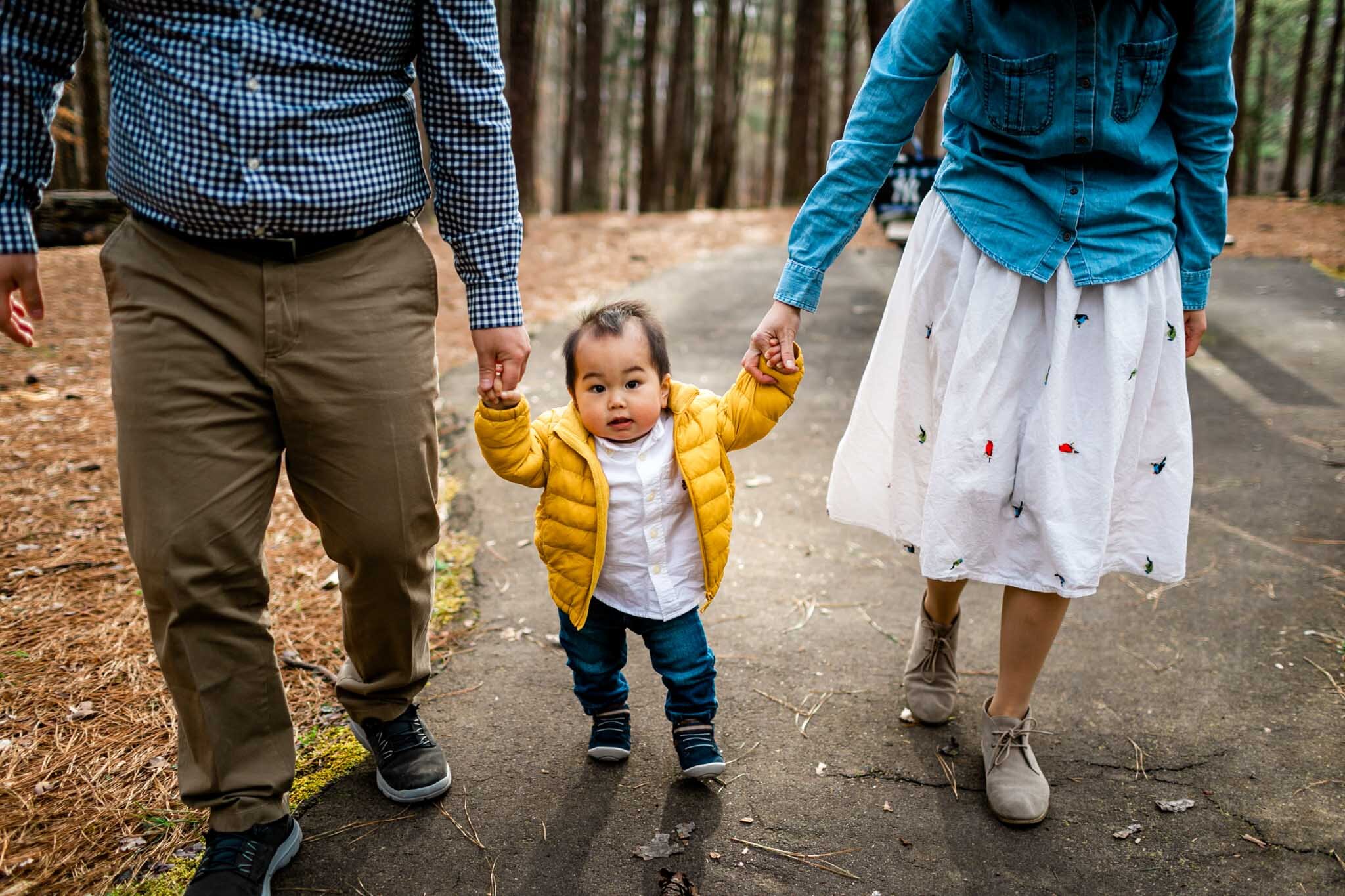 Raleigh Family Photographer | By G. Lin Photography | Umstead Park | Baby boy walking while holding hands