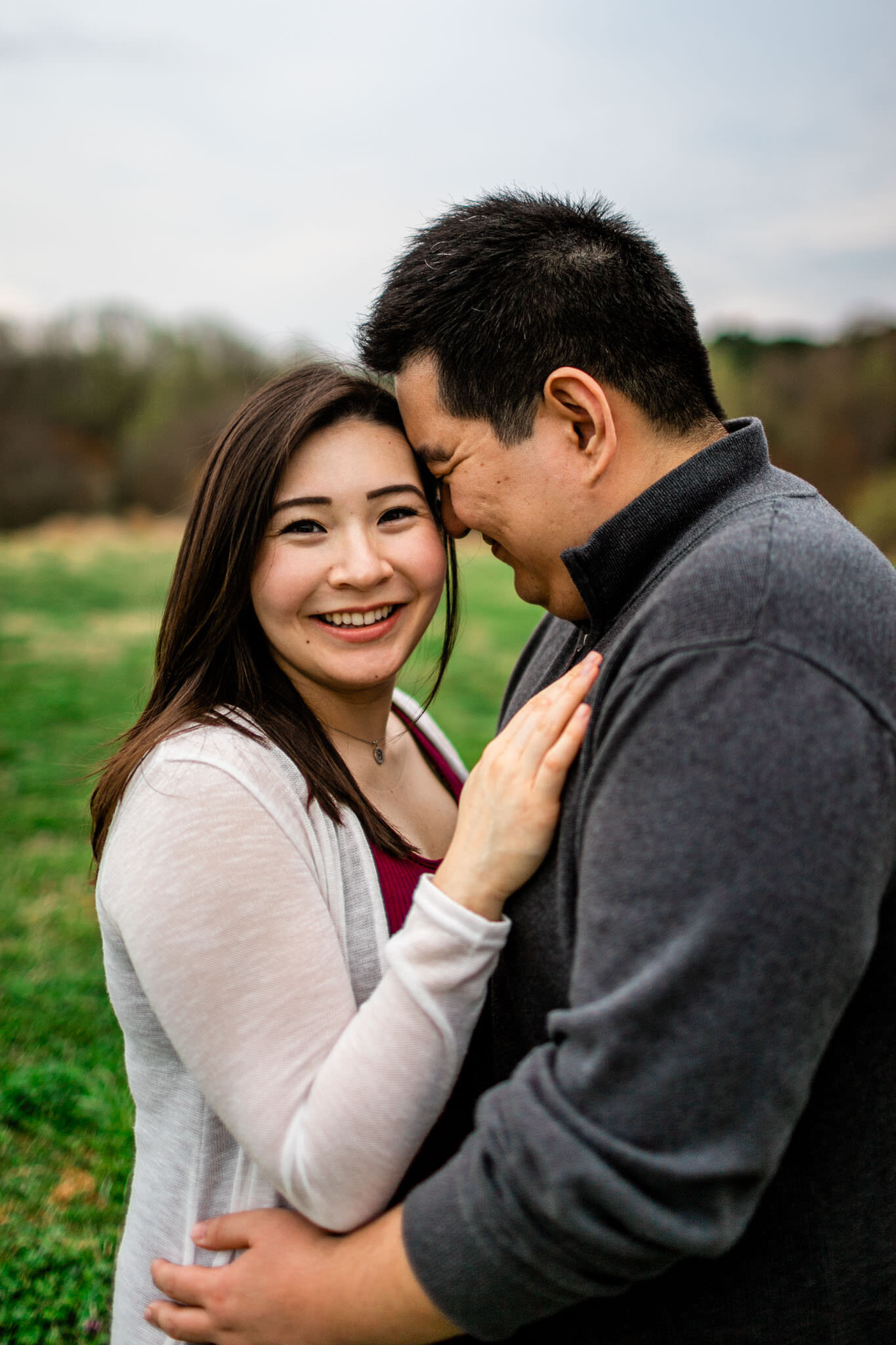 Raleigh Maternity Photographer | By G. Lin Photography | NC Museum of Art | Candid couple portrait with woman looking at camera