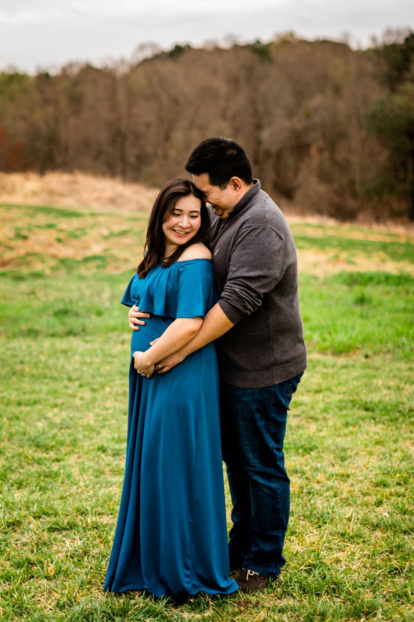 Raleigh Maternity Photographer | By G. Lin Photography | NC Museum of Art | Beautiful candid maternity shot of couple in open field