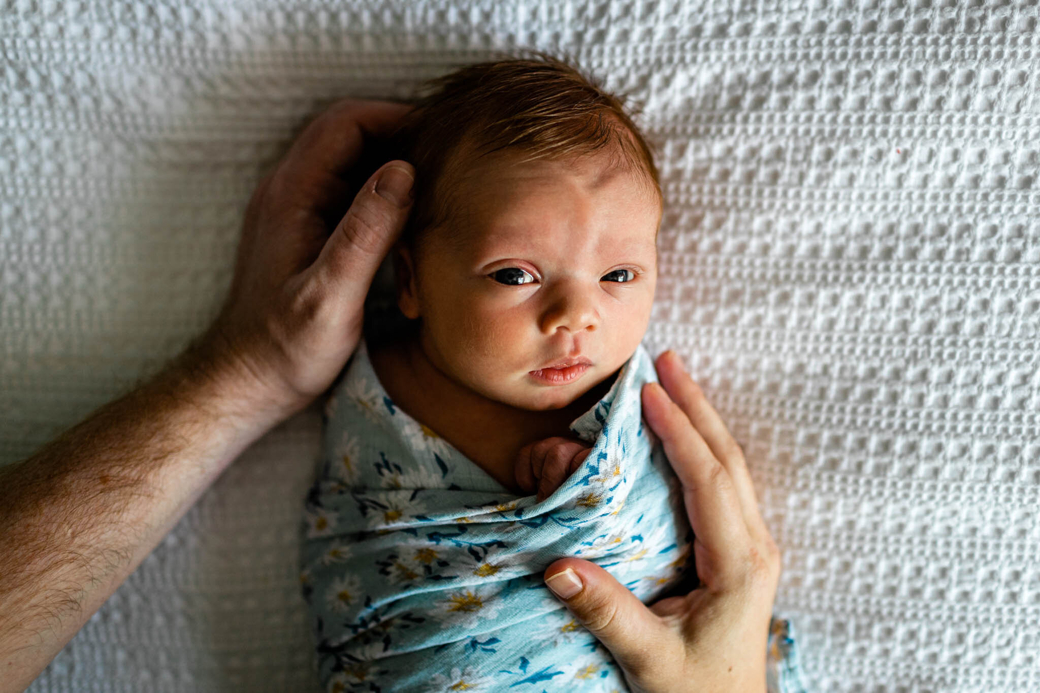 Durham Newborn Photographer | By G. Lin Photography | Baby girl laying on bed looking at camera