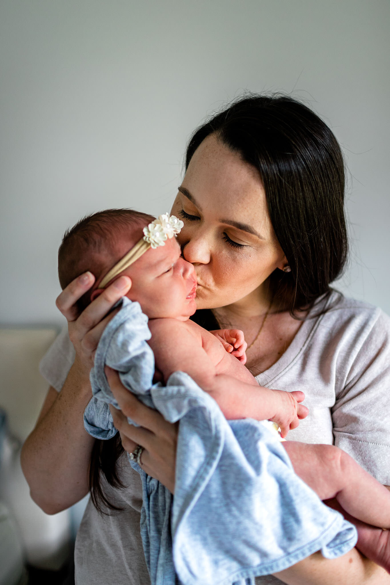 Mother kissing baby girl | Holly Spring Newborn Photographer | By G. Lin Photography