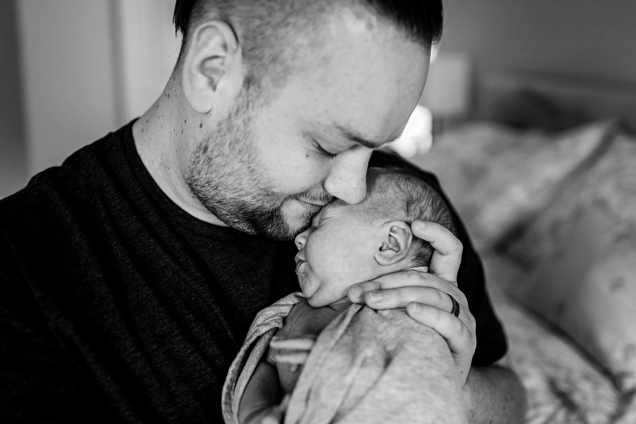 Black and white photo of dad holding baby | Holly Spring Newborn Photographer | By G. Lin Photography
