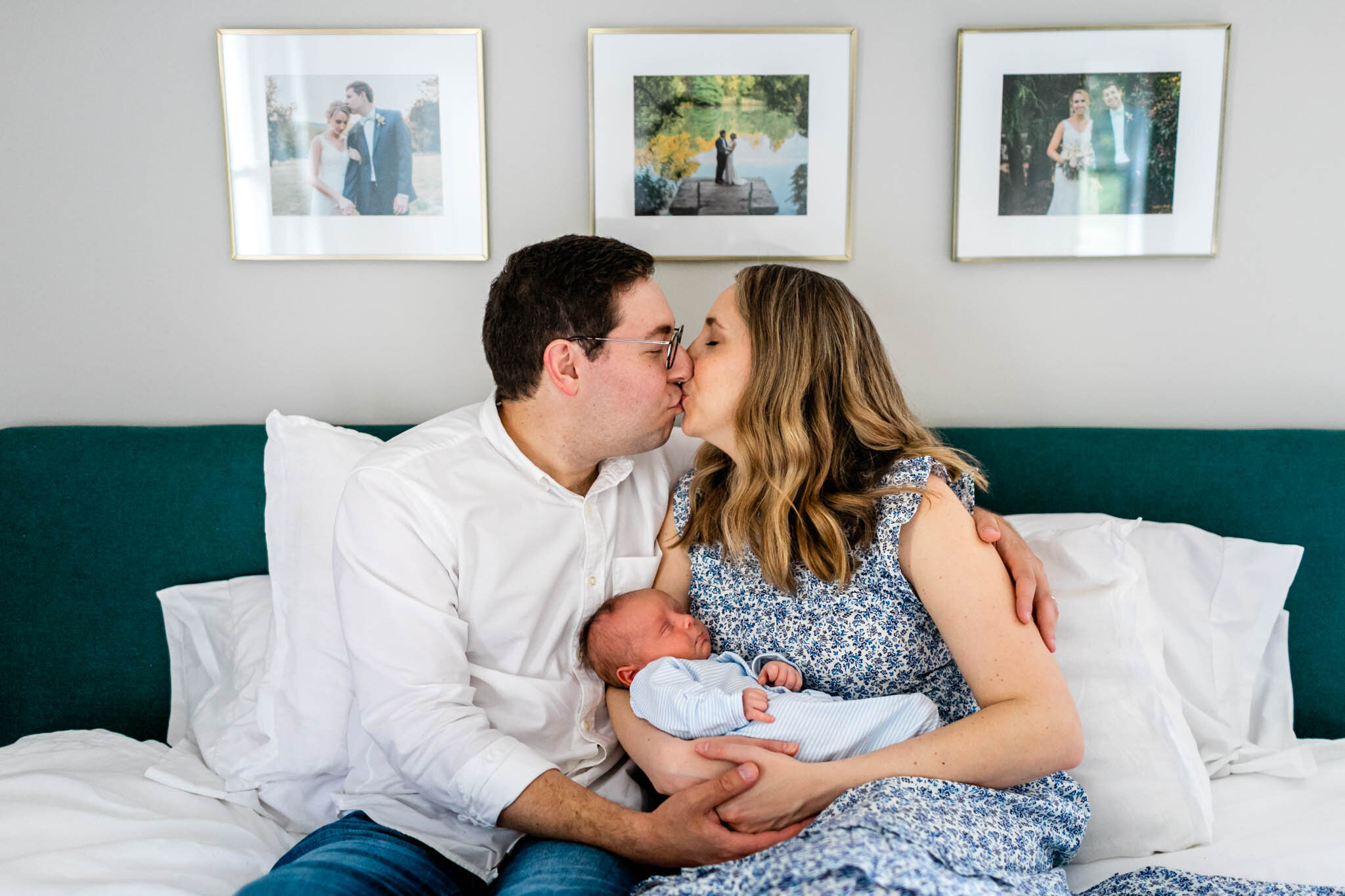 Parents kissing while holding baby | Greensboro Newborn Photographer | By G. Lin Photography