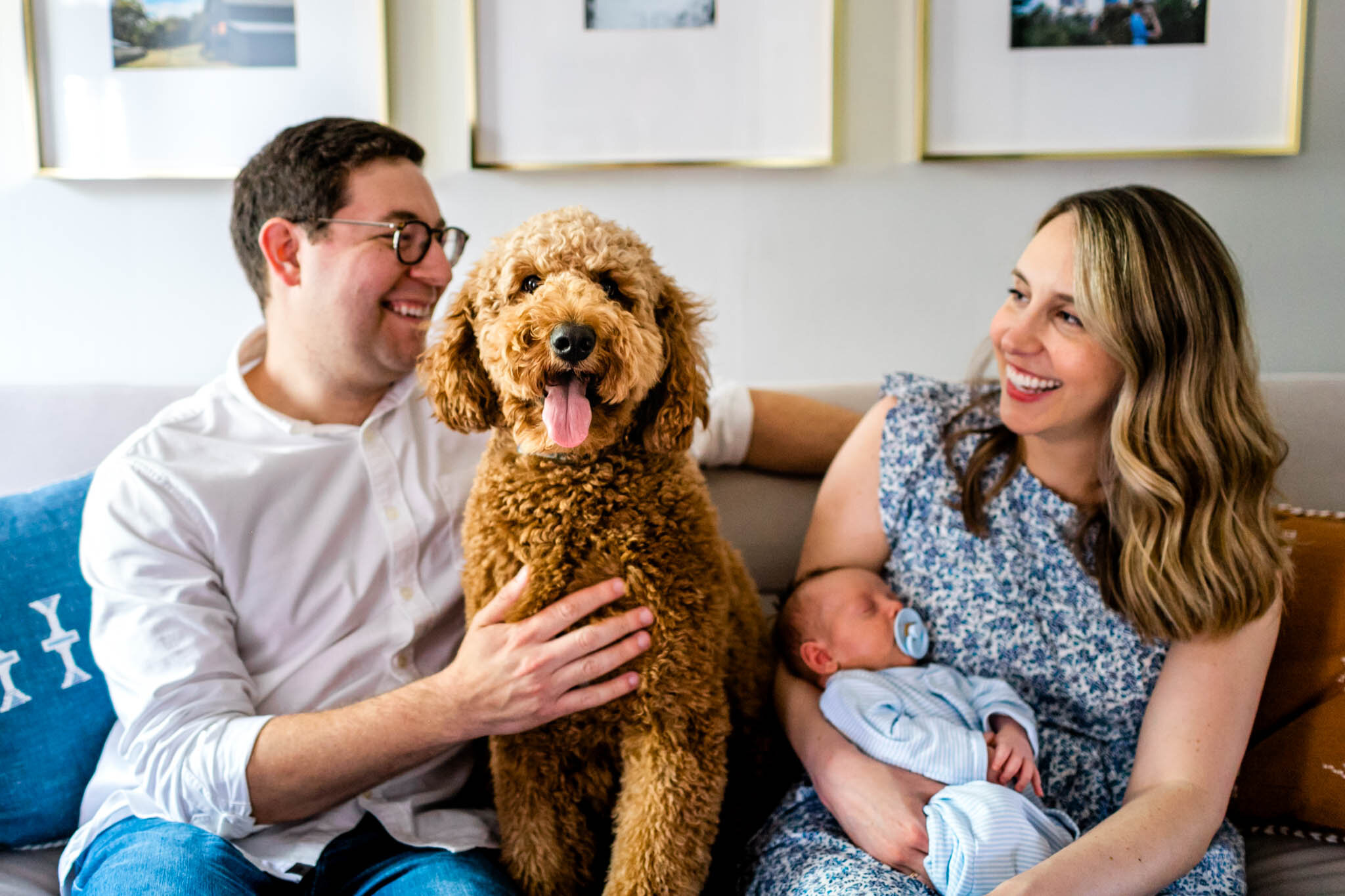 Candid photo of dog sitting in the middle of man and woman | Greensboro Newborn Photographer | By G. Lin Photography
