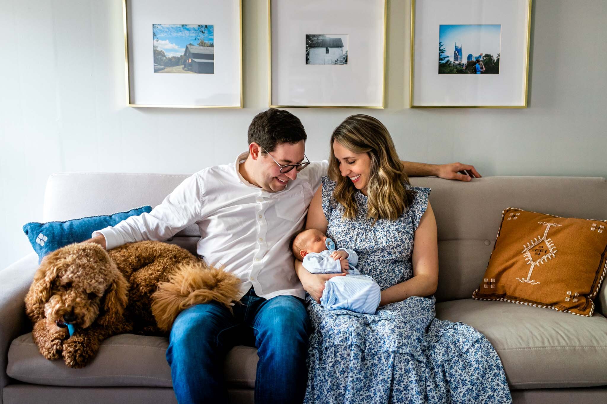 Family sitting on couch with dog and baby | Greensboro Newborn Photographer | By G. Lin Photography