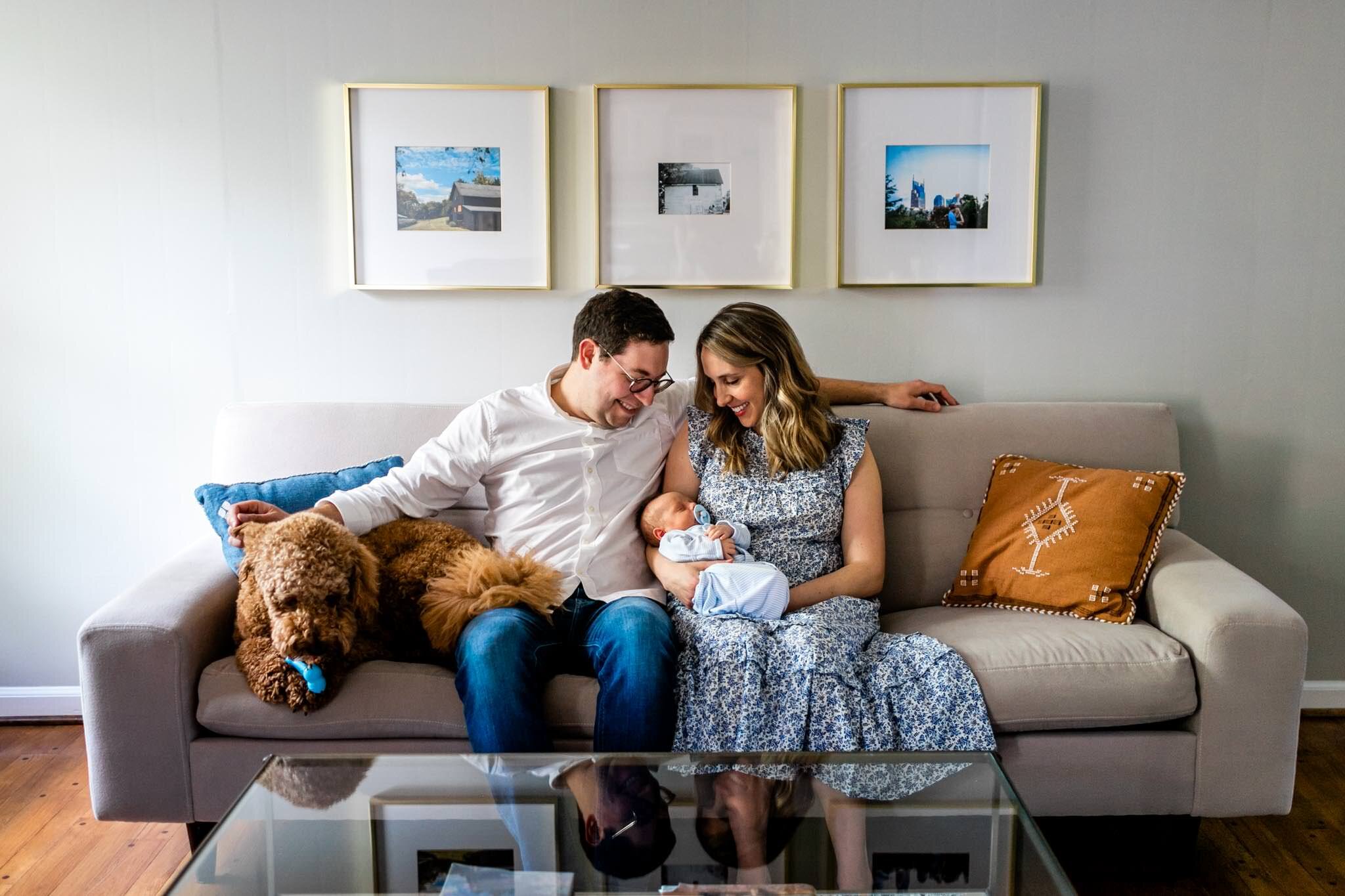 Beautiful lifestyle newborn photo of family sitting on couch | Greensboro Newborn Photographer | By G. Lin Photography