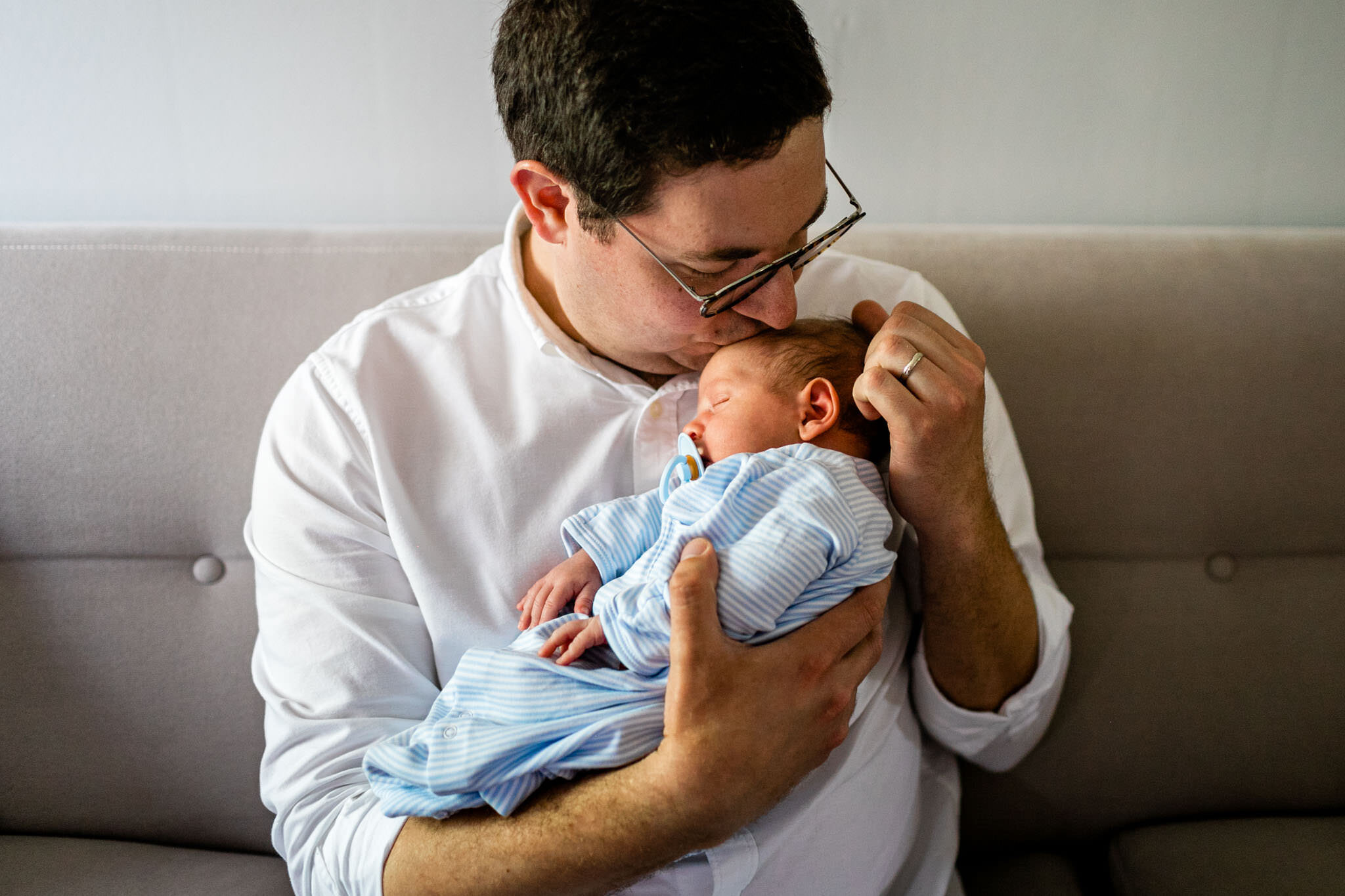 Father kissing baby boy | Greensboro Newborn Photographer | By G. Lin Photography