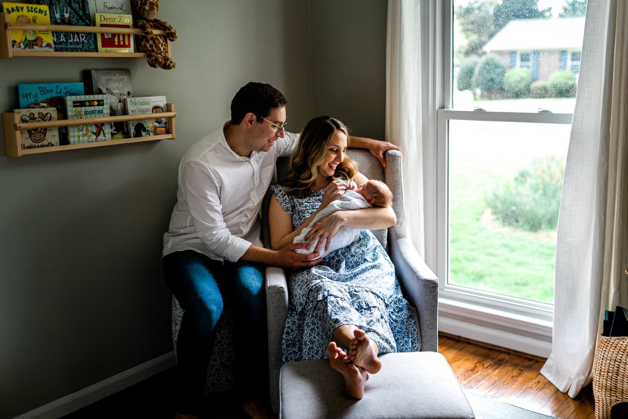 Greensboro Newborn Photographer | By G. Lin Photography | Parents sitting next to window with baby