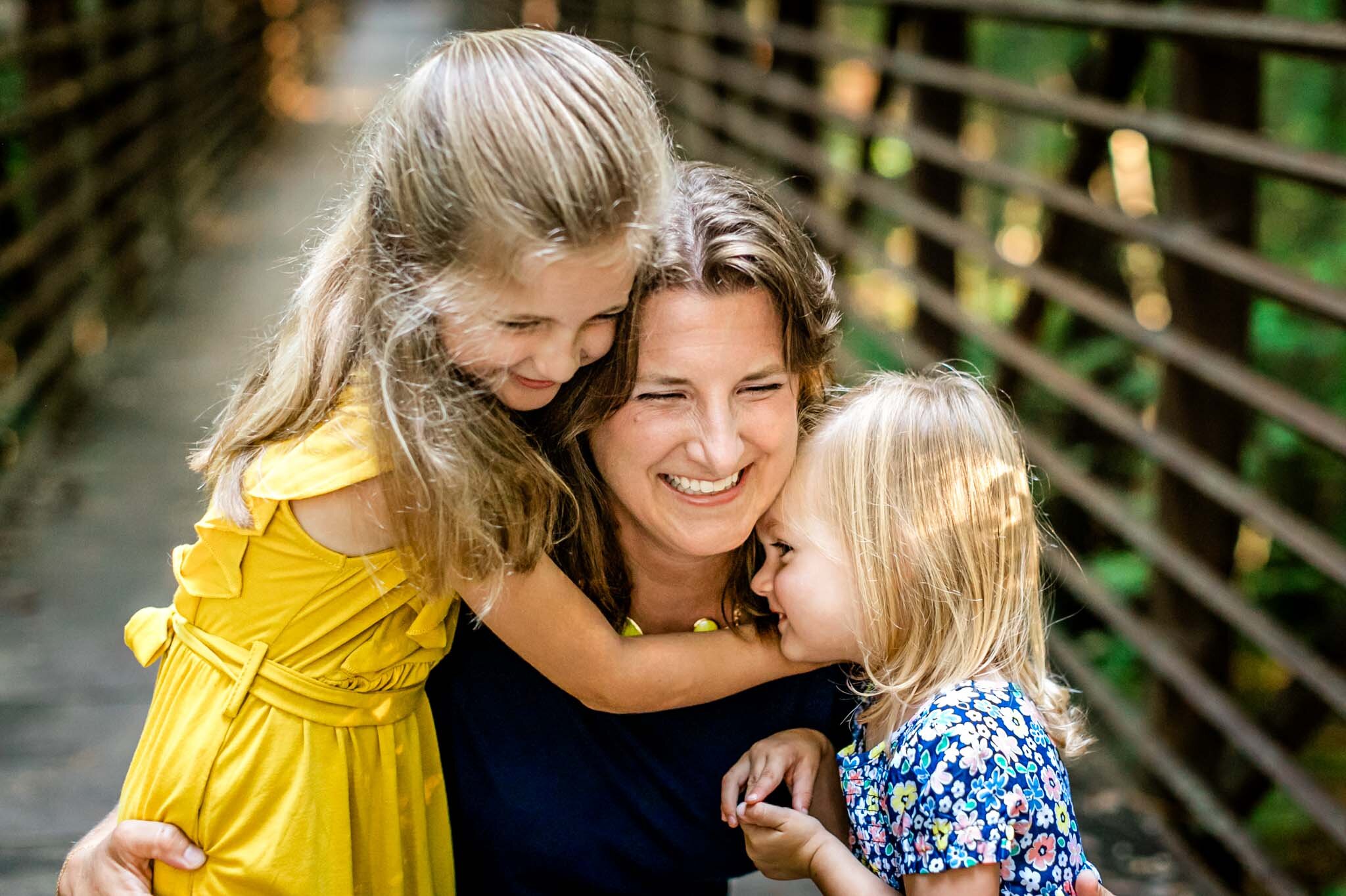 Two young girls hugging mother | Cary Family Photographer | By G. Lin Photography