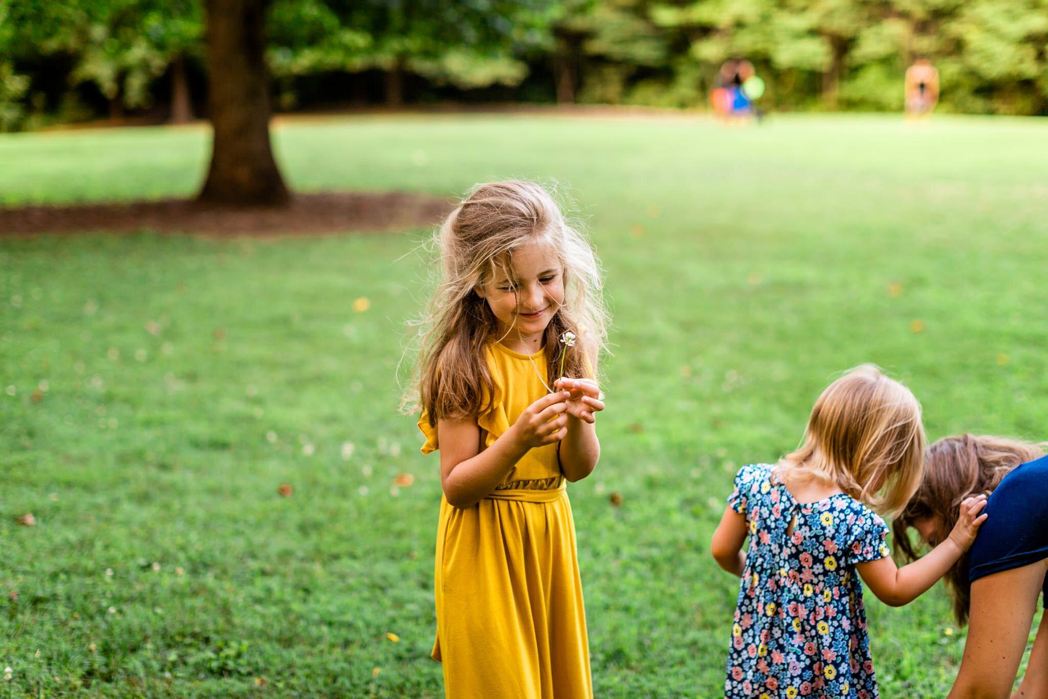 Girl in yellow dress picking flower | Cary Family Photographer | By G. Lin Photography | North Cary Park