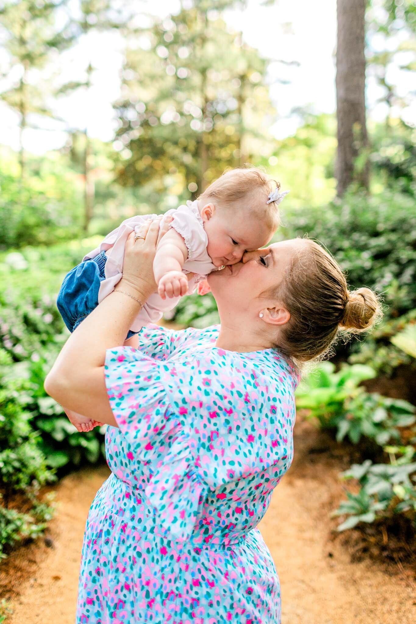 Mom giving baby girl a kiss | Raleigh Family Photographer | By G. Lin Photography | WRAL Azalea Garden