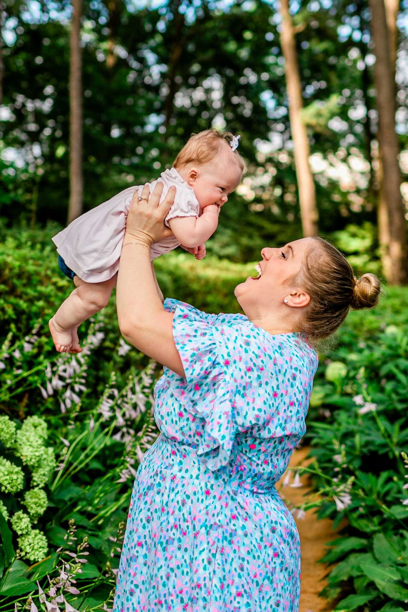 Mother holding baby girl in the air | Raleigh Family Photographer | By G. Lin Photography | WRAL Azalea Garden