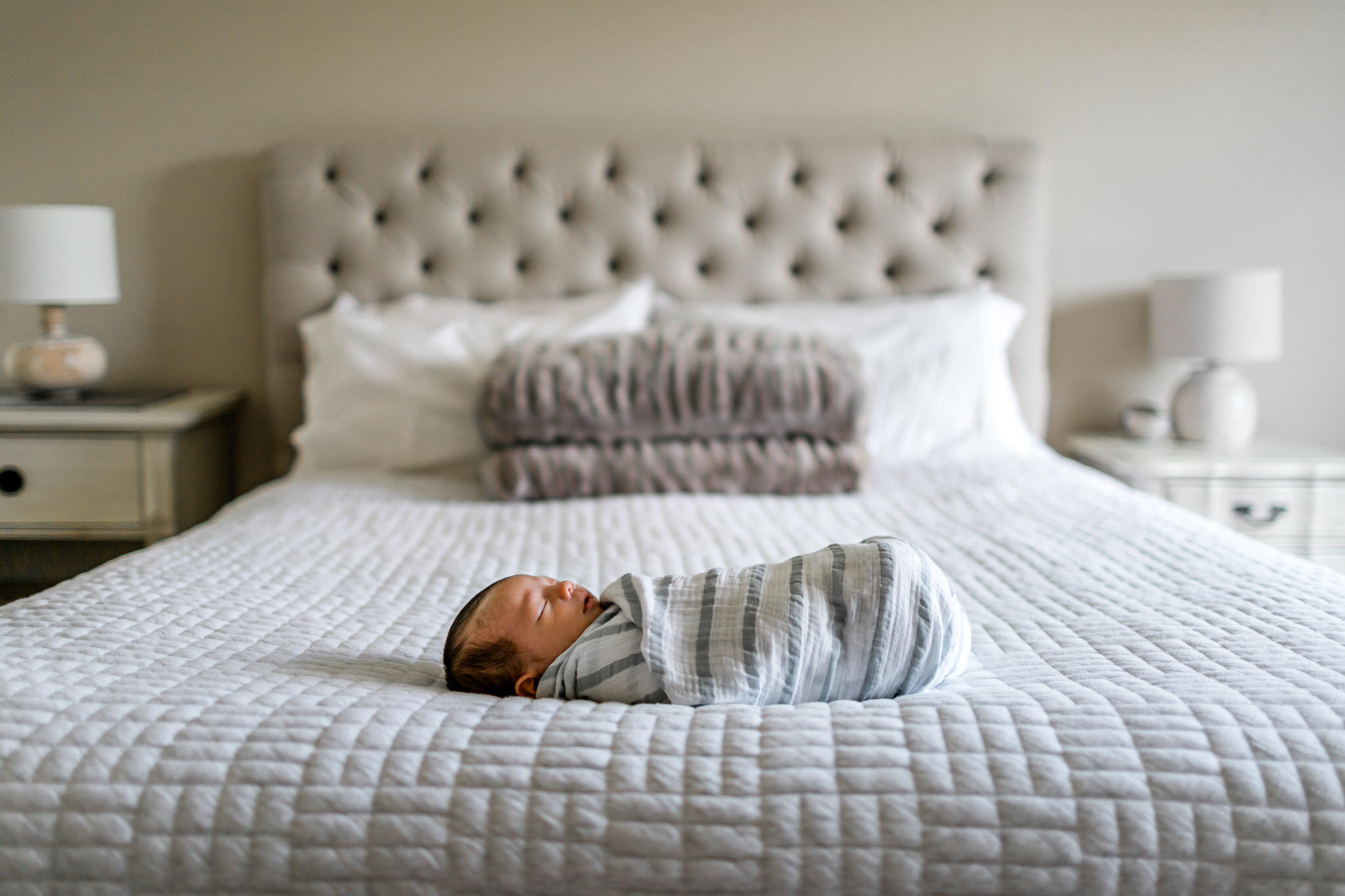 Baby laying on white bed | Durham Newborn Photographer | By G. Lin Photography