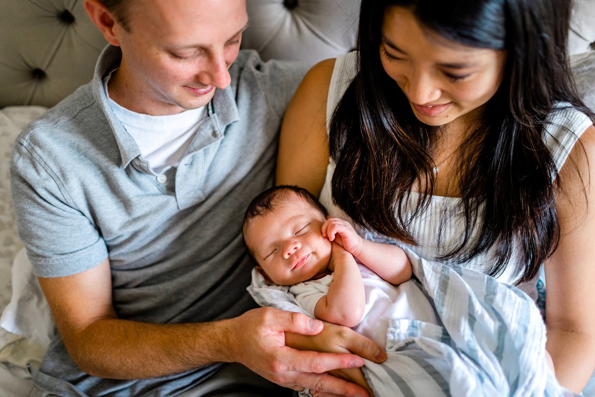 Baby smiling with hands on face | Durham Newborn Photographer | By G. Lin Photography