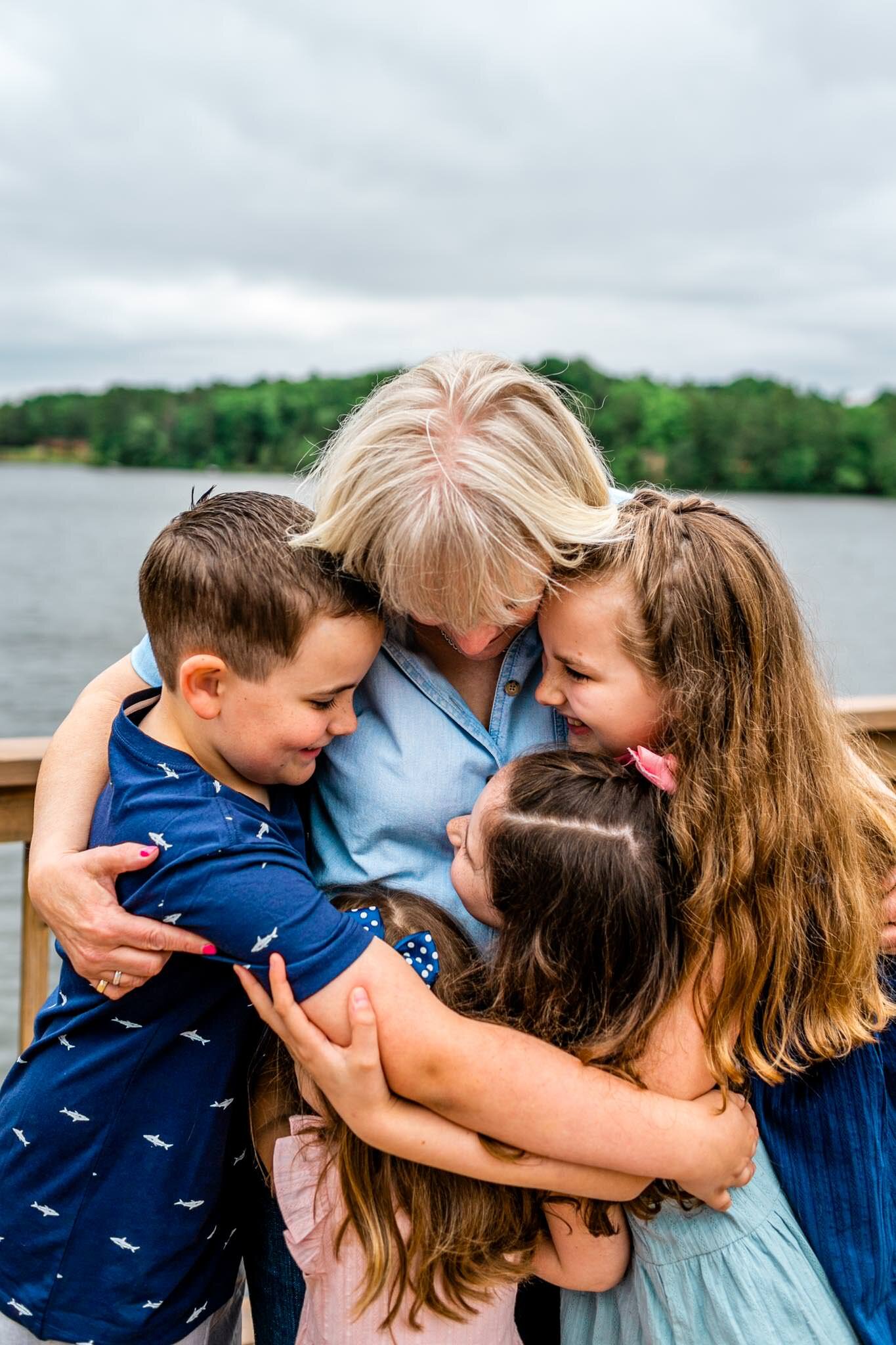 Lake Gaston Family Photographer | By G. Lin Photography | Candid photo of grandma hugging four grandchildren