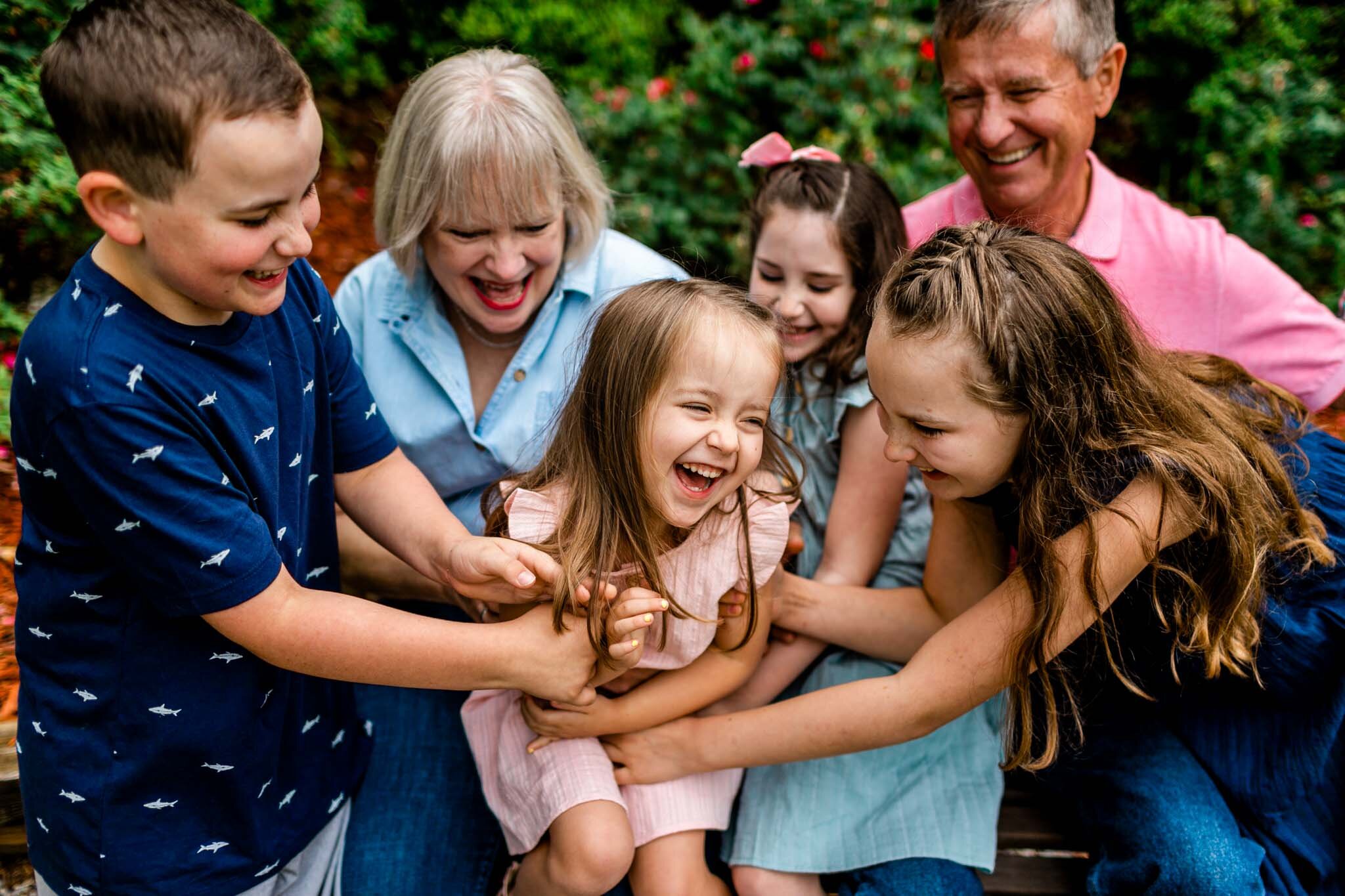 Kids tickling little girl and laughing | Lake Gaston Family Photographer | By G. Lin Photography