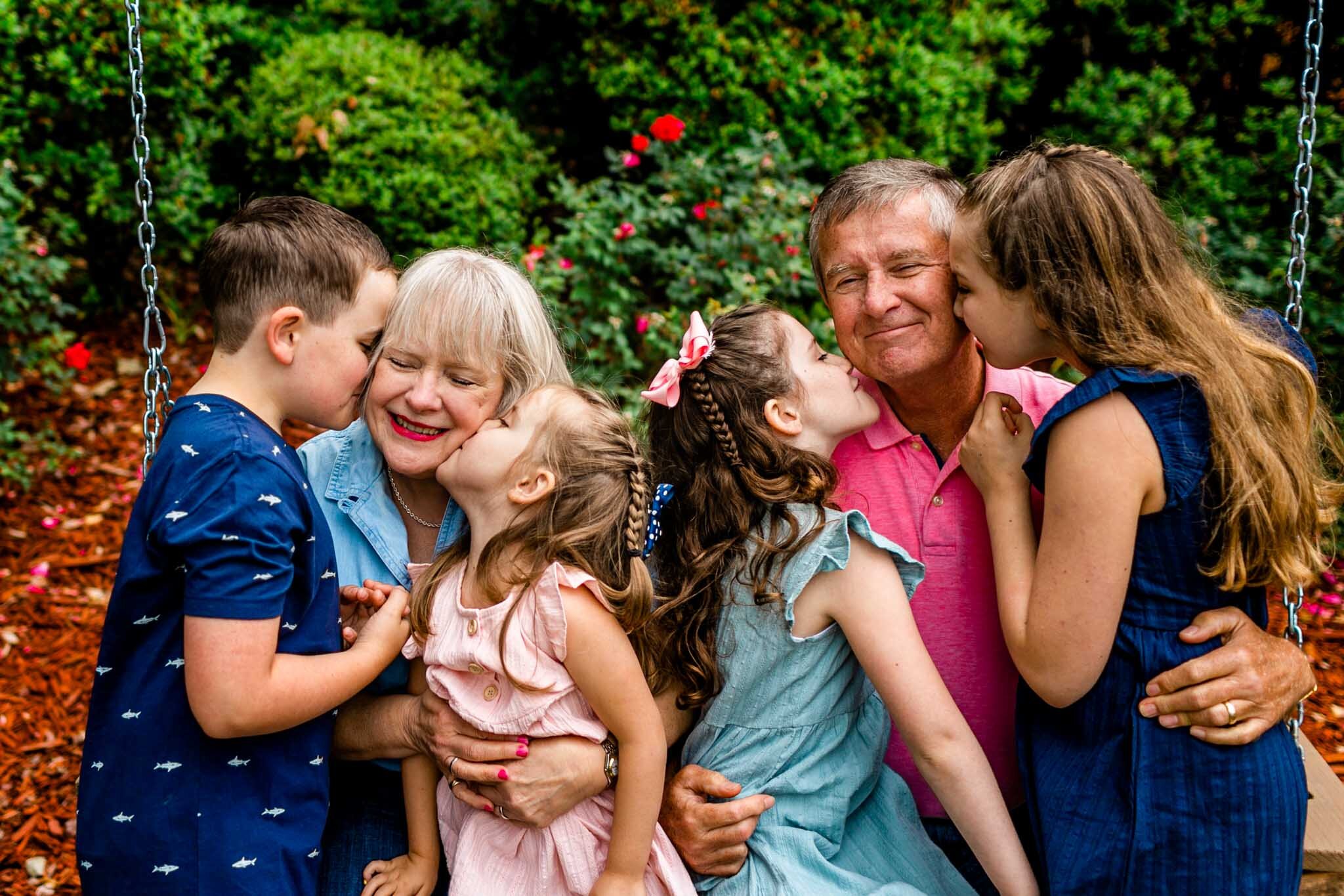 Sweet photo of grandkids kissing grandparents | Lake Gaston Family Photographer | By G. Lin Photography