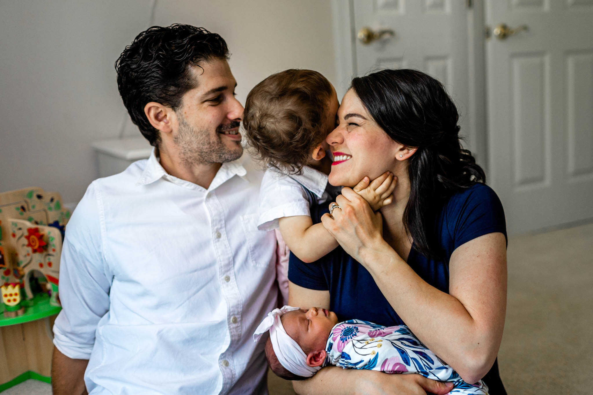 Little boy hugging parents inside home | Durham Newborn Photographer | By G. Lin Photography