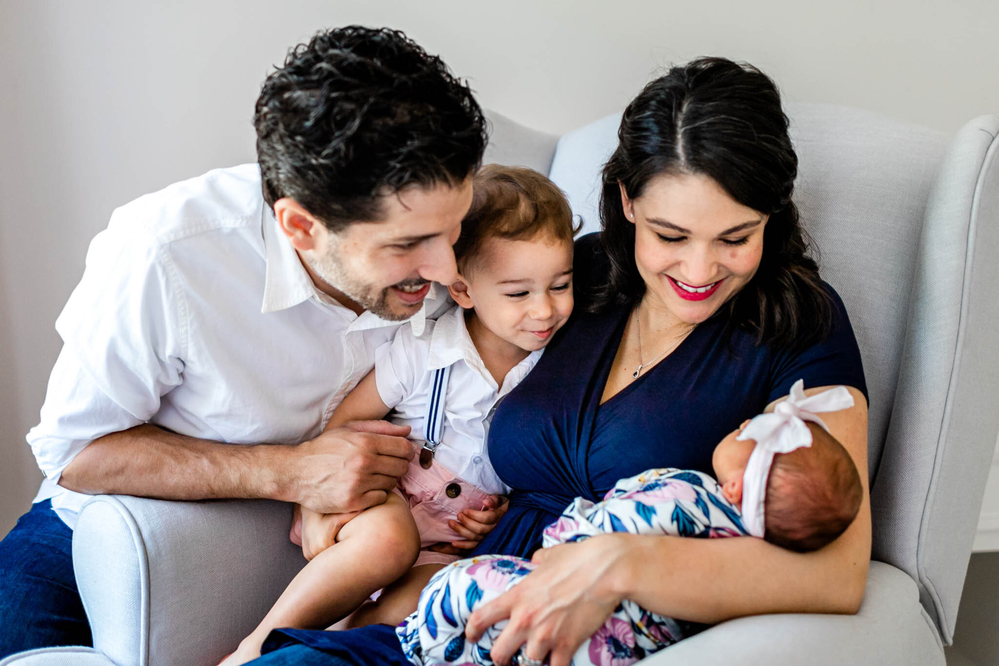 Candid family photo looking at baby girl | Lifestyle newborn session at home | Durham Newborn Photographer | By G. Lin Photography