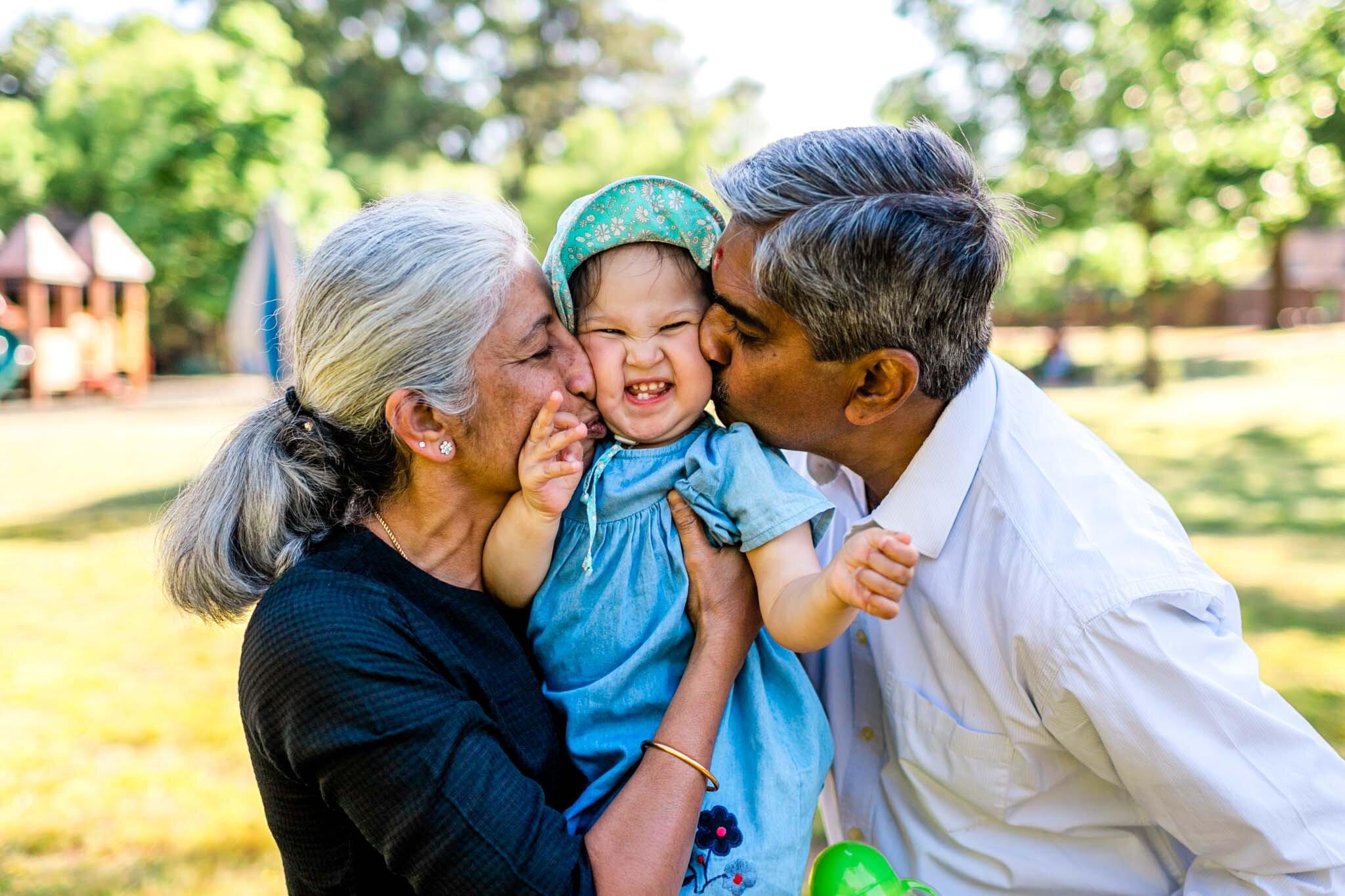 Grandparents kissing baby on cheeks | Forest Hills Park | Durham Family Photographer | By G. Lin Photography