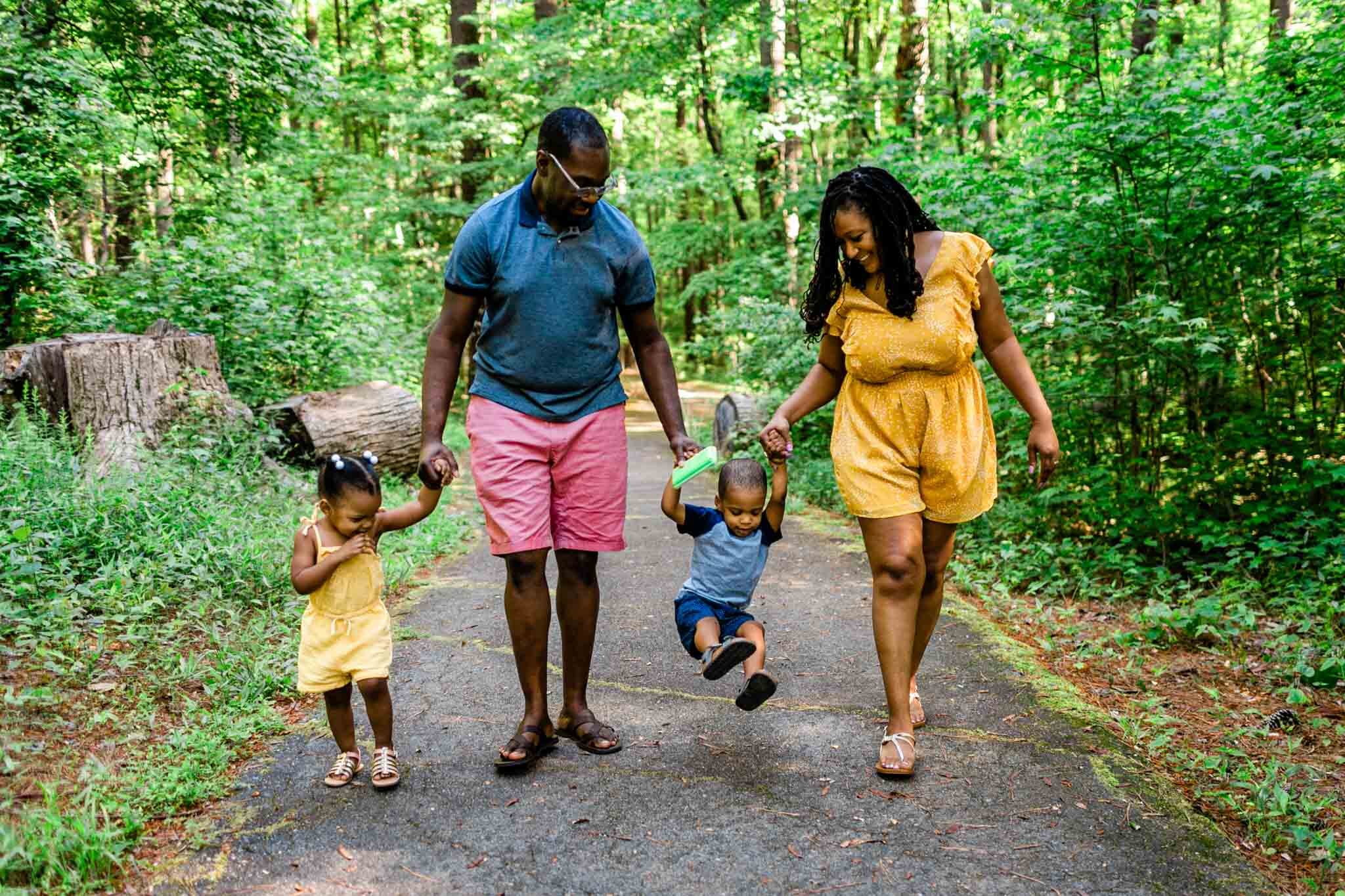 Family holding hands and walking | Raleigh Family Photographer | By G. Lin Photography | Umstead Park