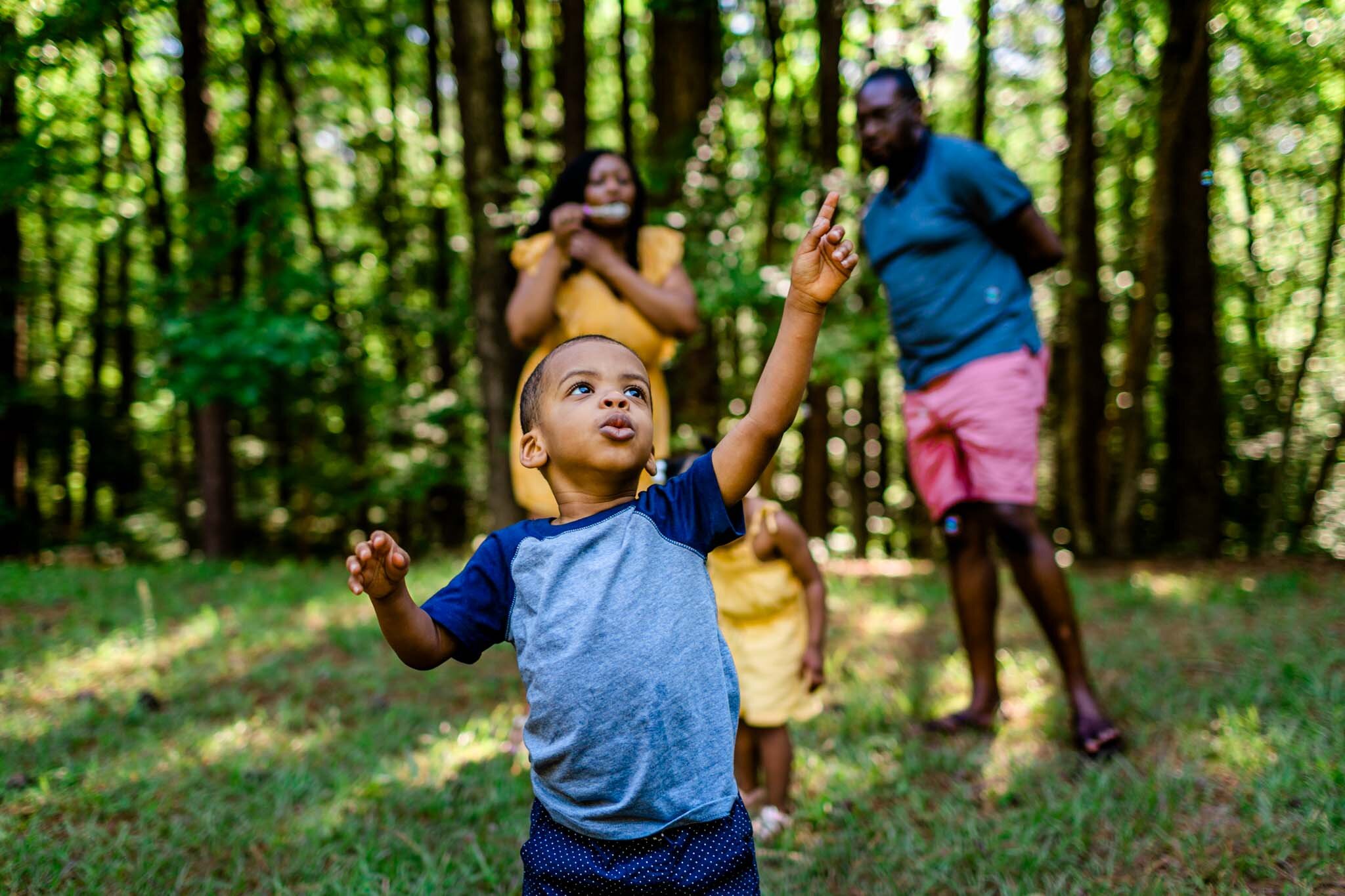 Young boy popping bubbles | Raleigh Family Photographer | By G. Lin Photography | Umstead Park