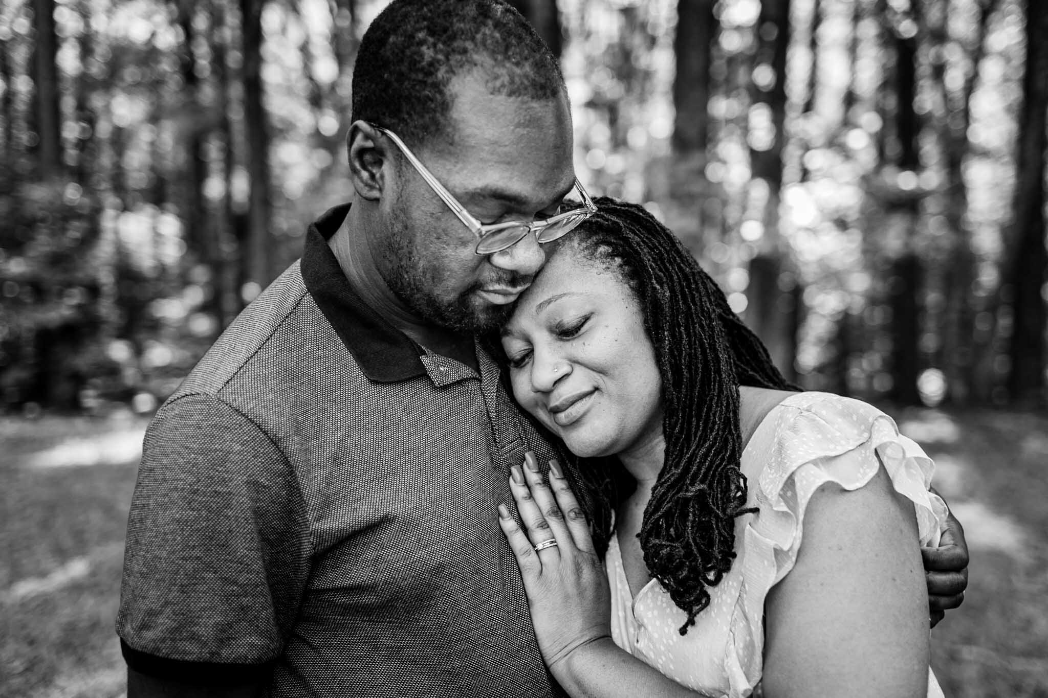 Beautiful black and white photo of couple hugging one another | Raleigh Family Photographer | By G. Lin Photography | Umstead Park