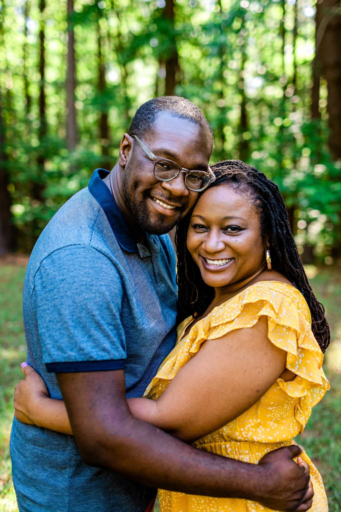 Husband and wife smiling at camera | Raleigh Family Photographer | By G. Lin Photography | Umstead Park