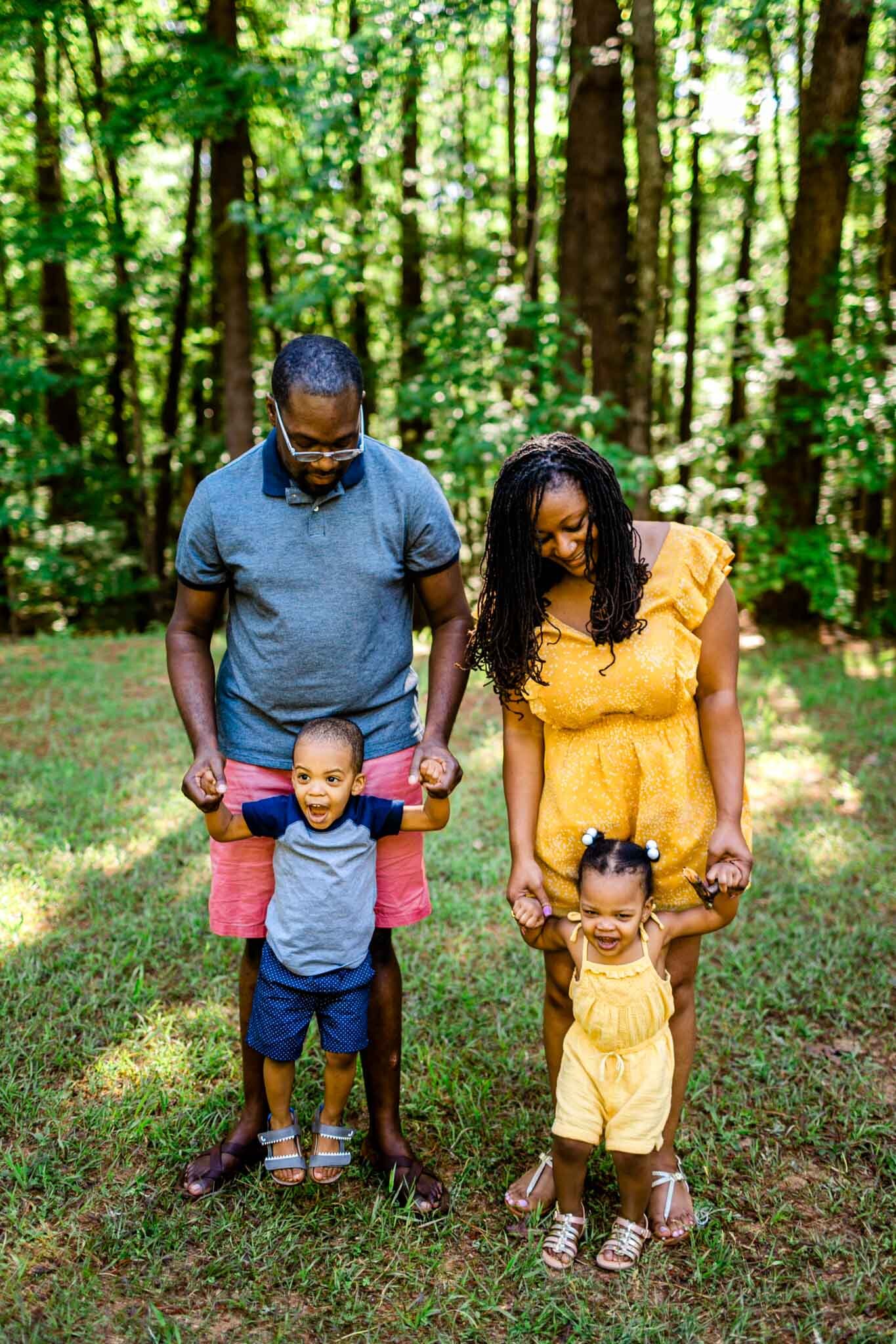 Parents holding childrens hands | Raleigh Family Photographer | By G. Lin Photography | Umstead Park
