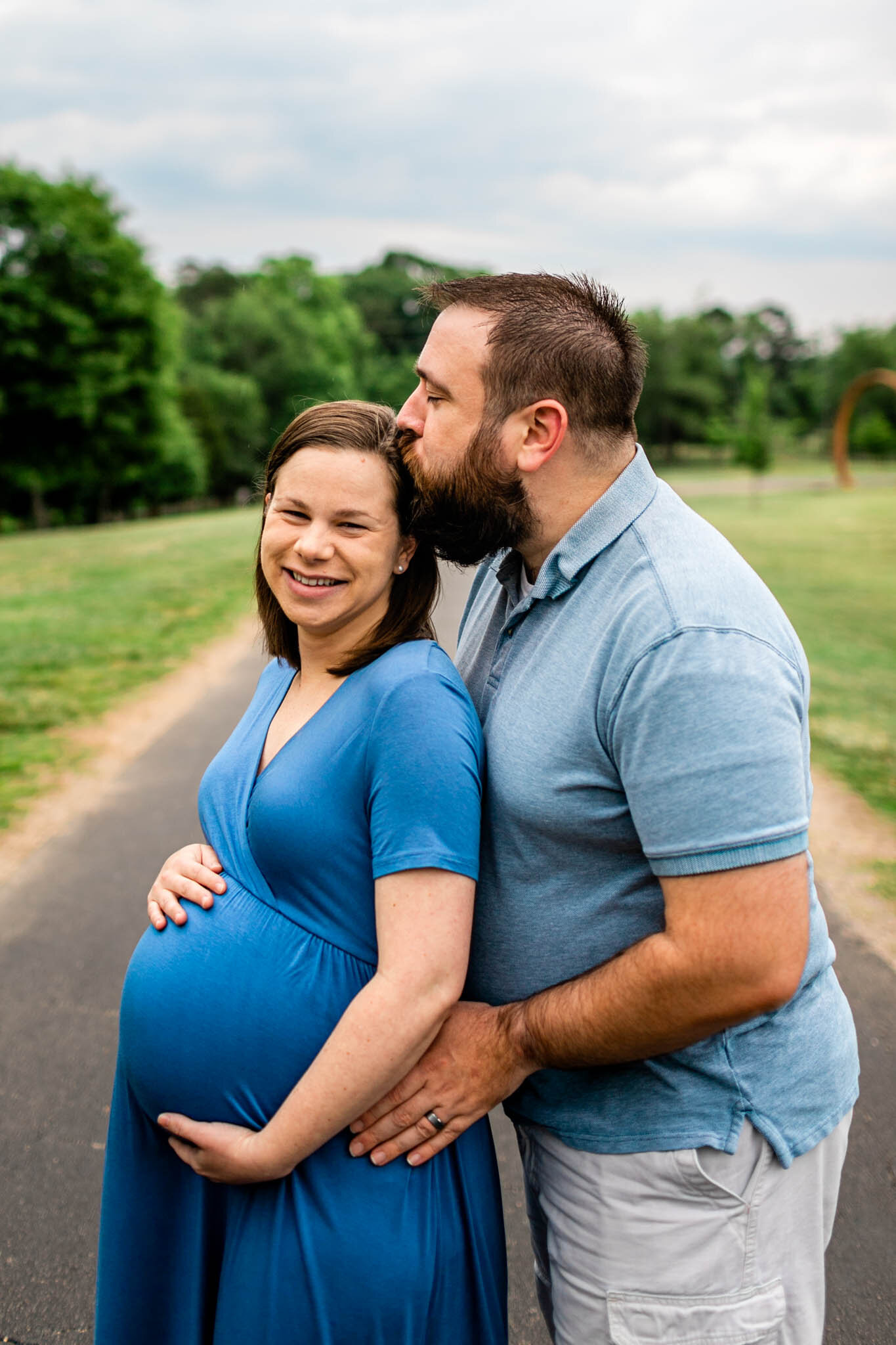 Husband kissing wife | Spring Maternity Session at NCMA | Raleigh Maternity Photographer | By G. Lin Photography 