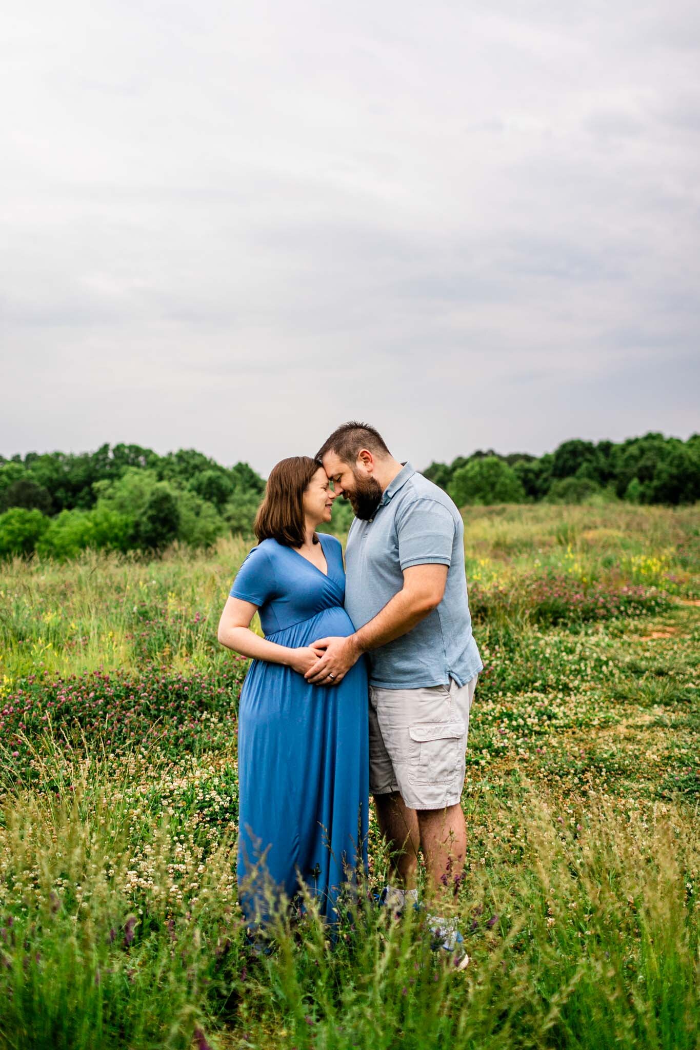 Raleigh Maternity Photographer | By G. Lin Photography | Couple hugging one another in open field | NCMA Maternity Photos