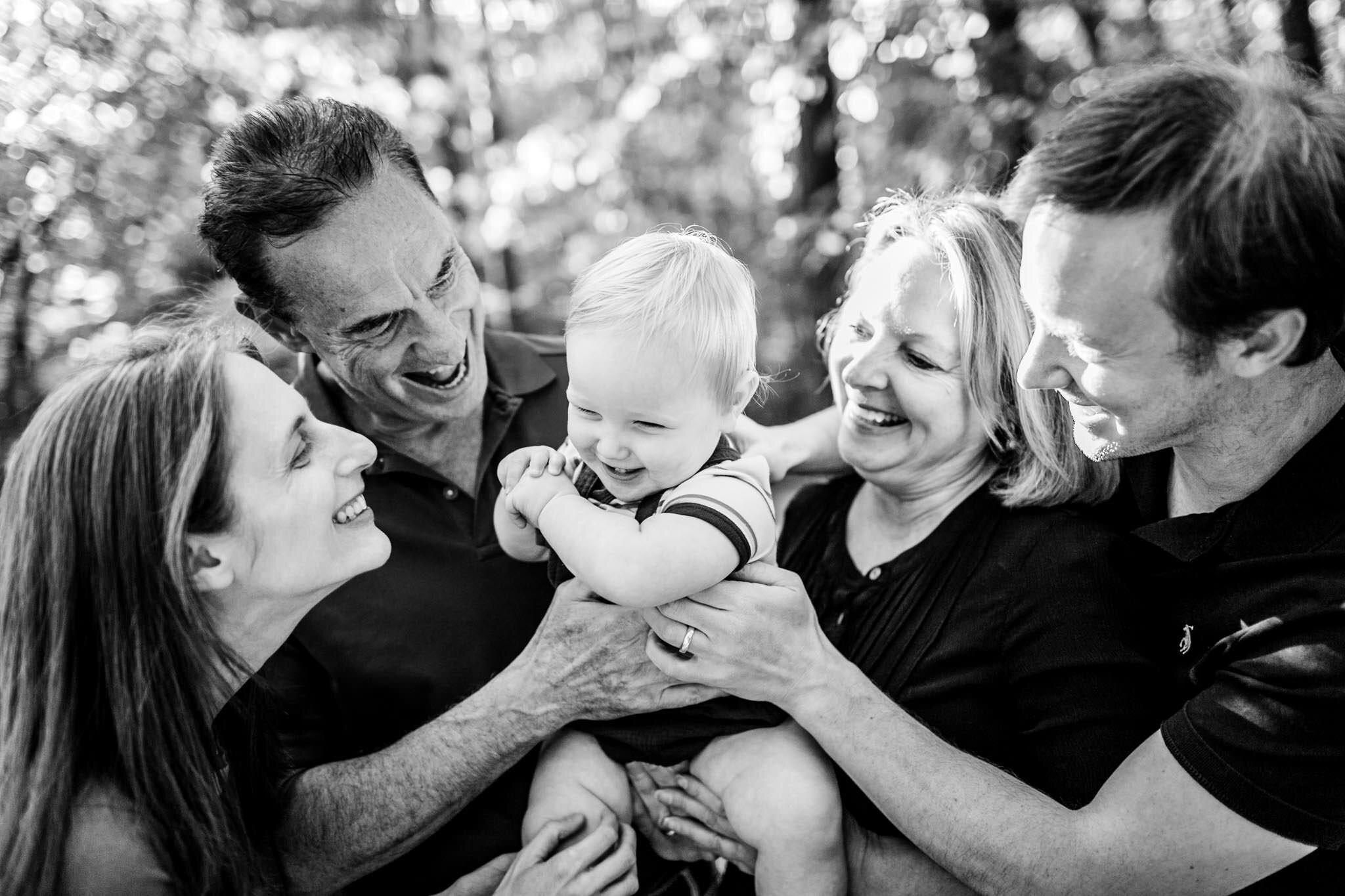 Raleigh Family Photographer | Umstead Park | By G. Lin Photography | Black and white photo of baby laughing