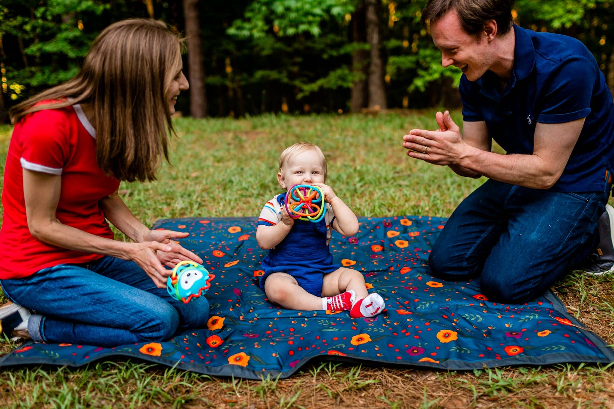 Raleigh Family Photographer | Umstead Park | By G. Lin Photography | Baby playing with toy