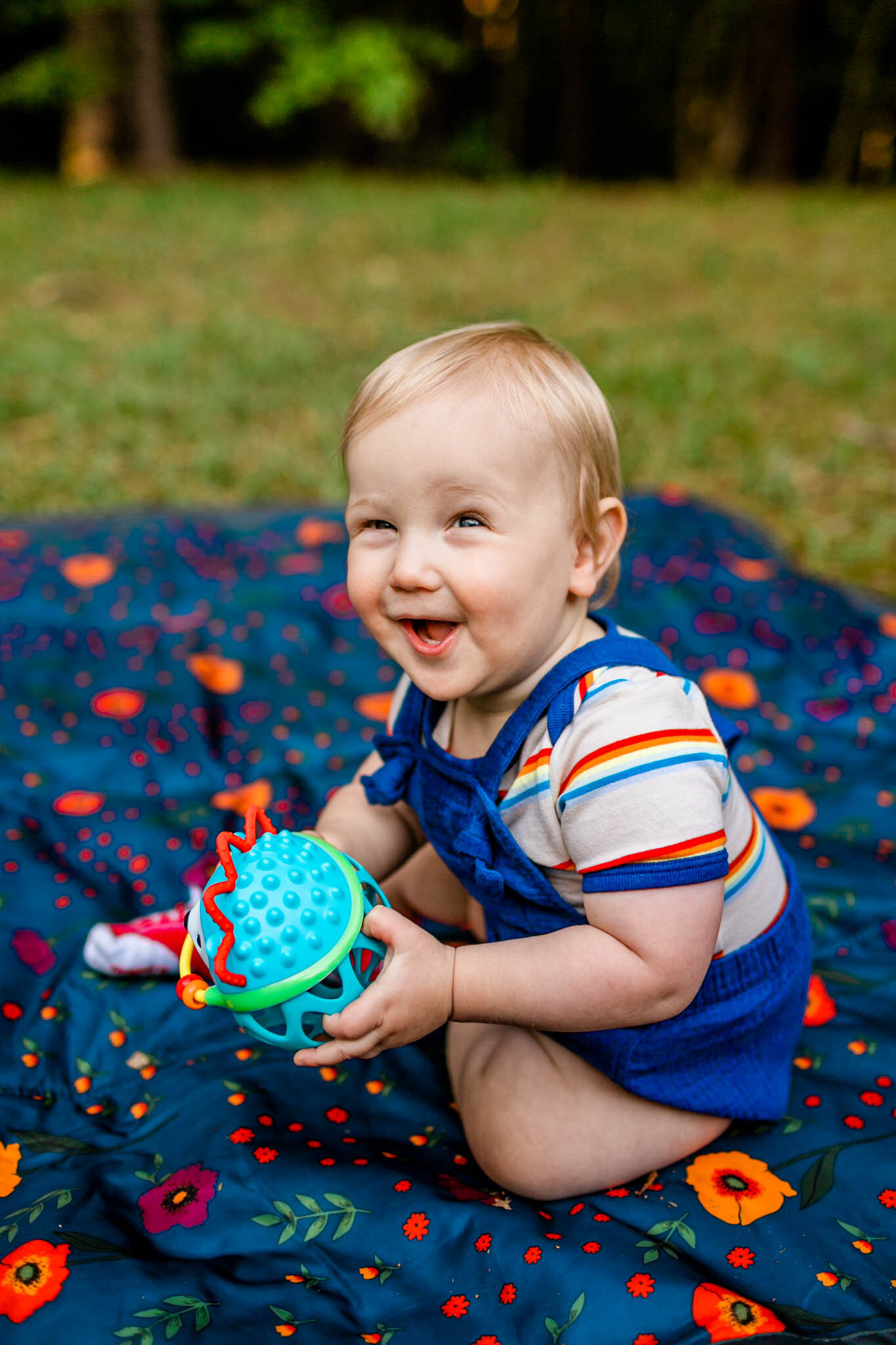 Raleigh Family Photographer | Umstead Park | By G. Lin Photography | Baby boy laughing and holding toy