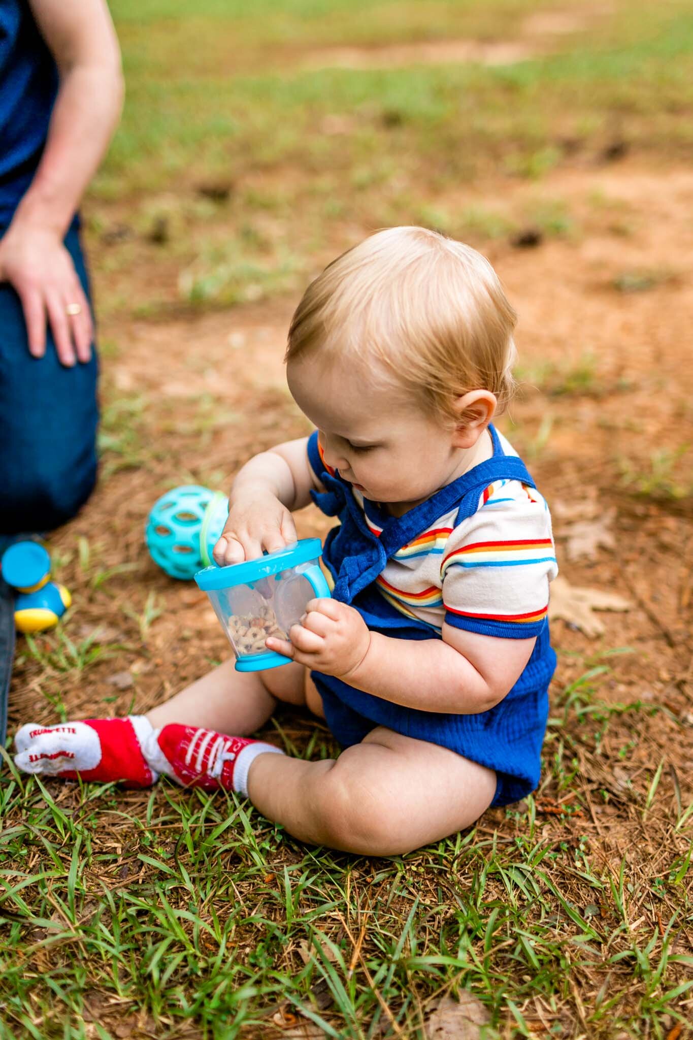 Raleigh Family Photographer | Umstead Park | By G. Lin Photography | Baby boy eating from cup