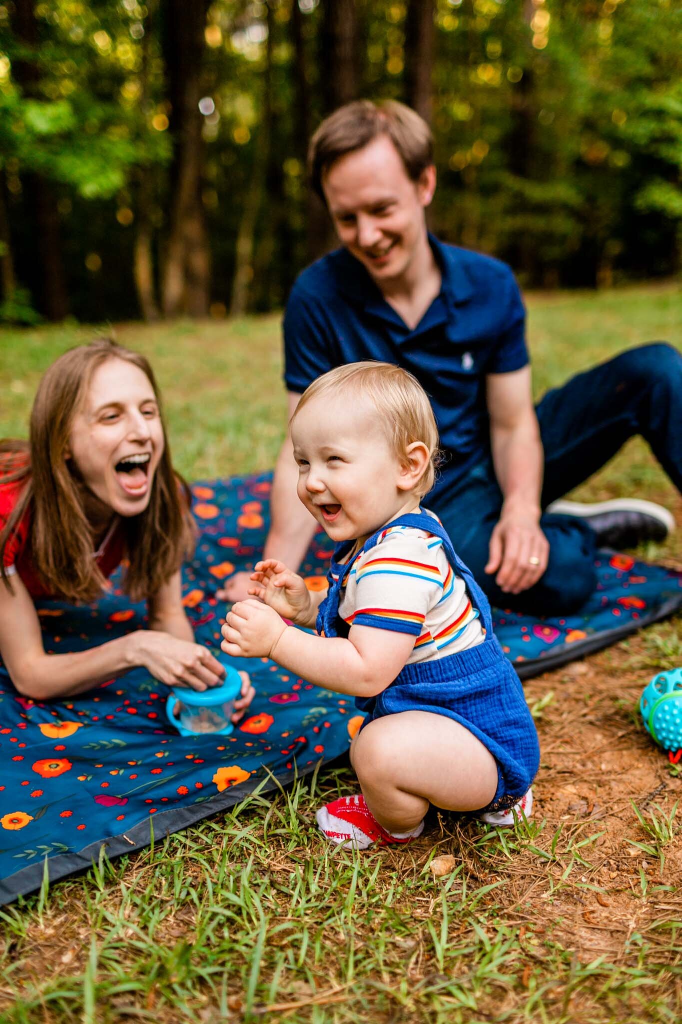 Mother and father laughing with baby boy | Raleigh Family Photographer | Umstead Park | By G. Lin Photography