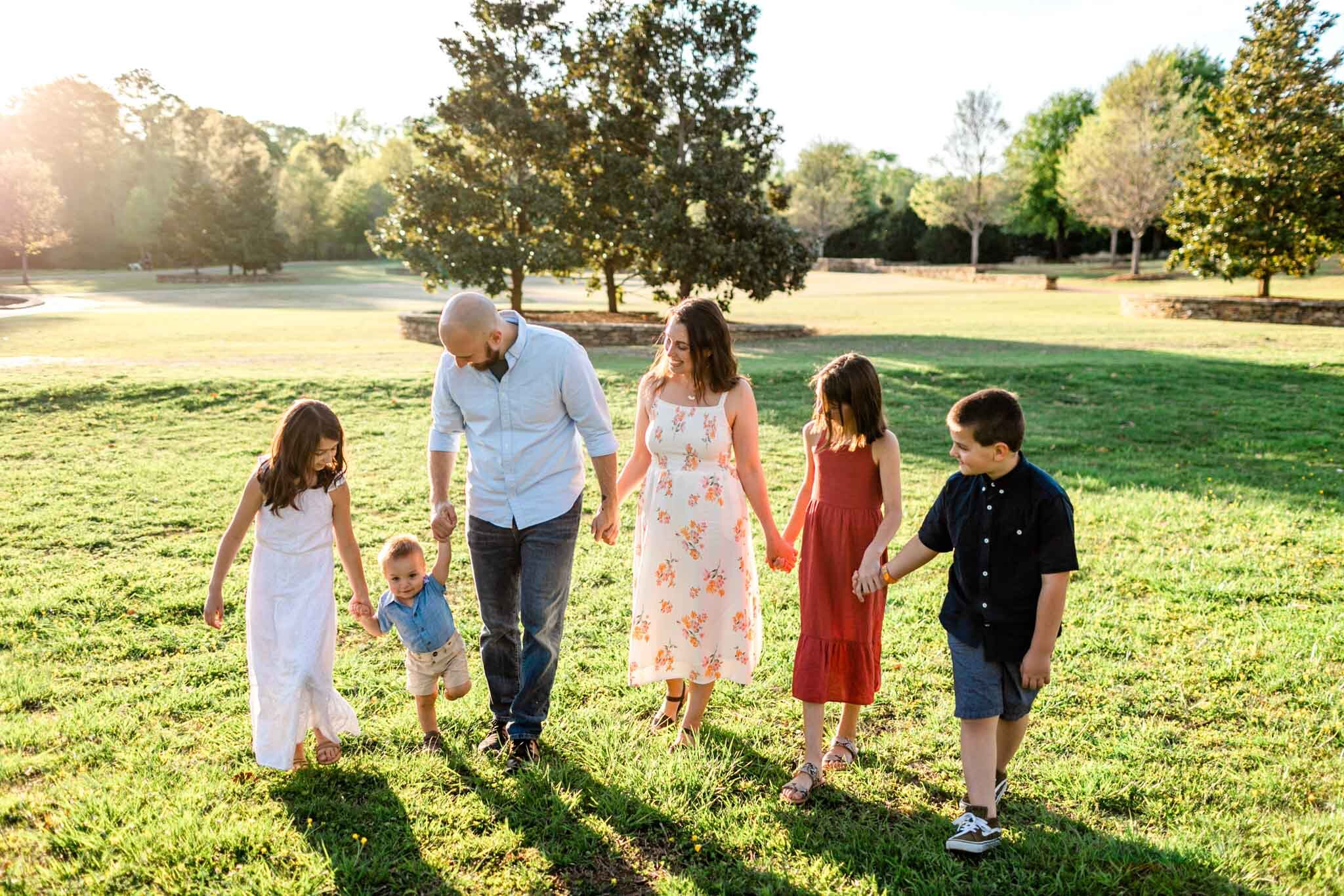 Raleigh Family Photographer | Joyner Park | By G. Lin Photography | Family walking together outdoors