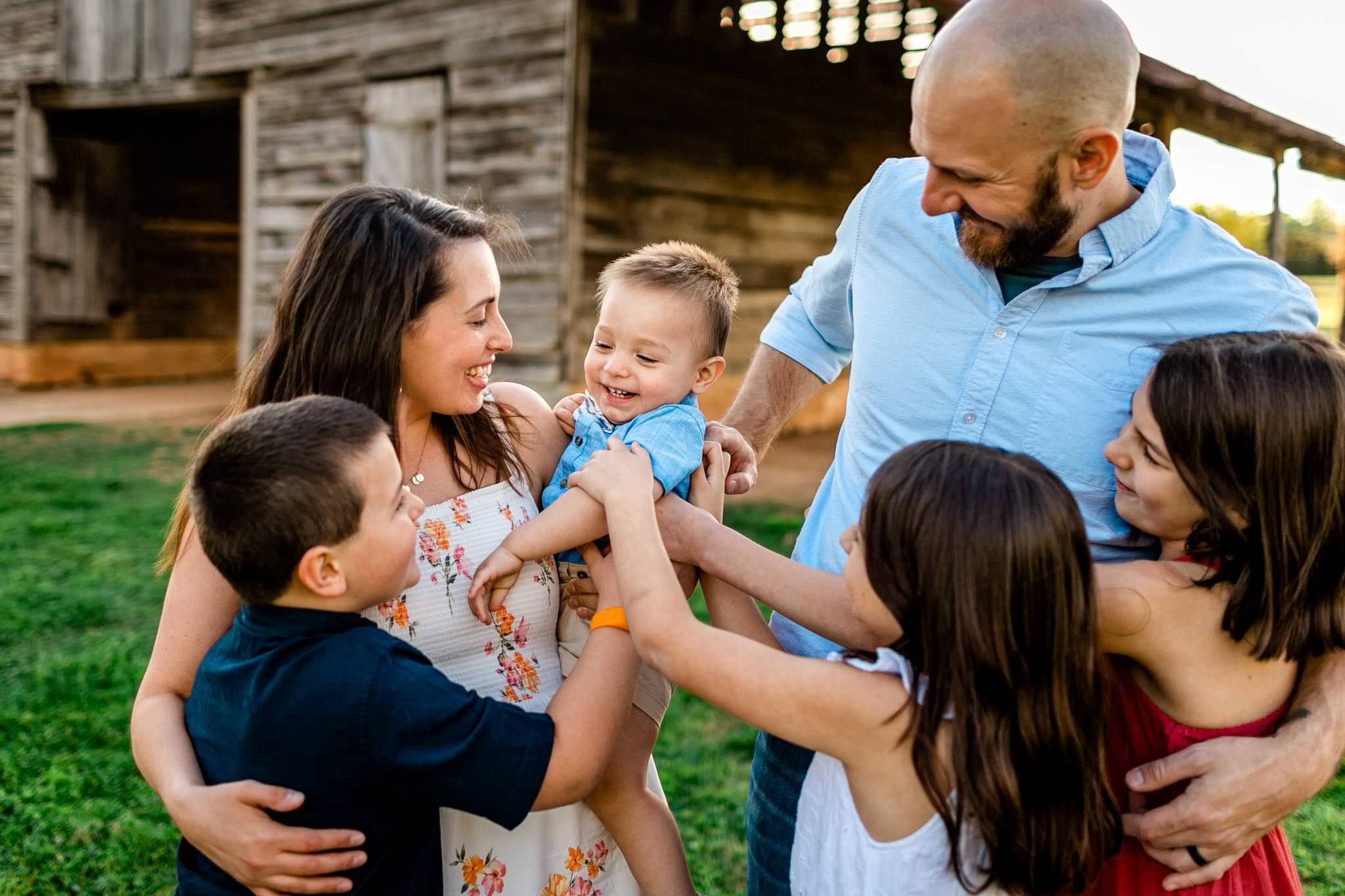 Raleigh Family Photographer | Joyner Park | By G. Lin Photography | Family tickling youngest boy