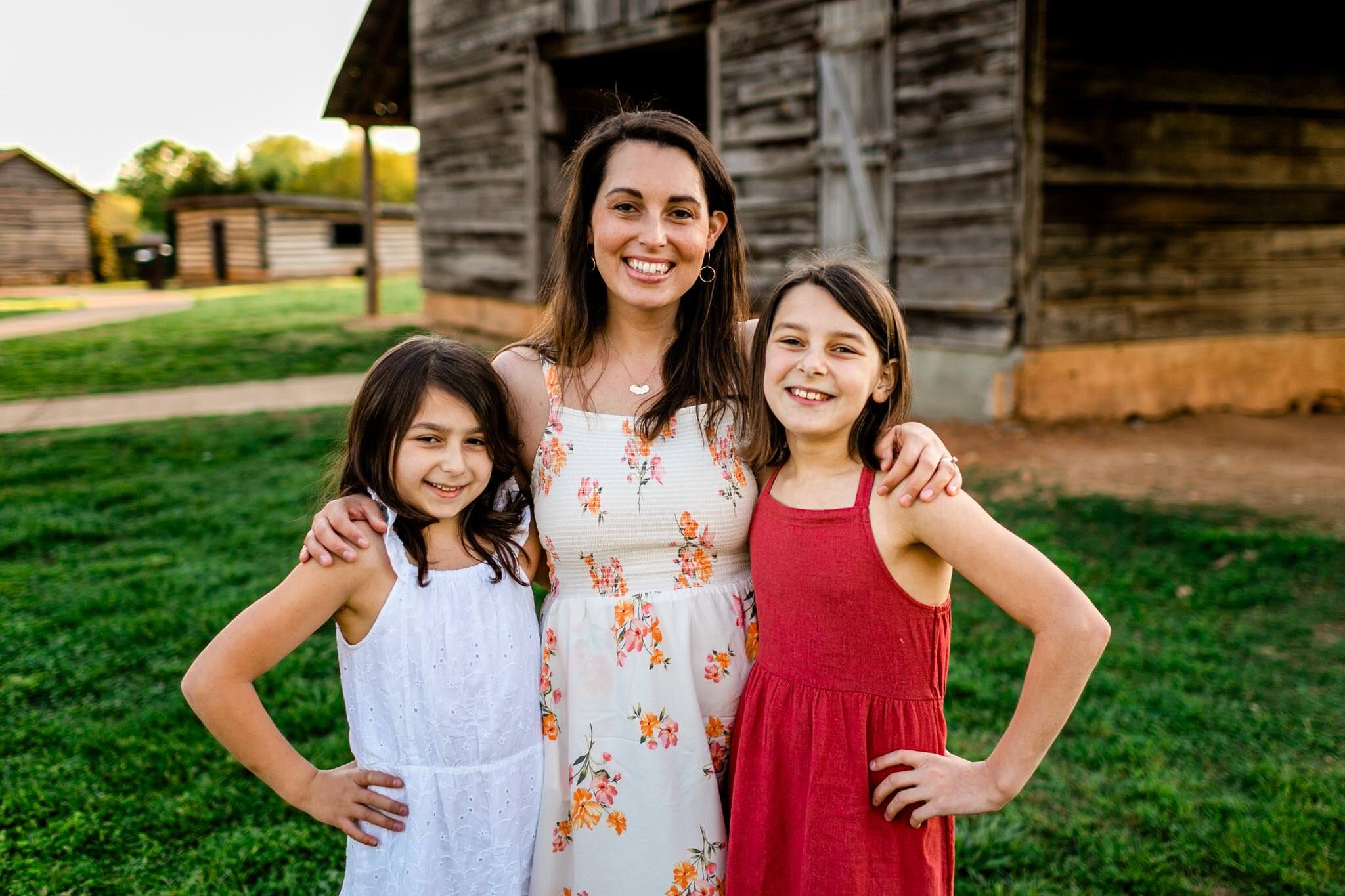 Mom with two girls smiling at camera outdoors | Raleigh Family Photographer | Joyner Park | By G. Lin Photography